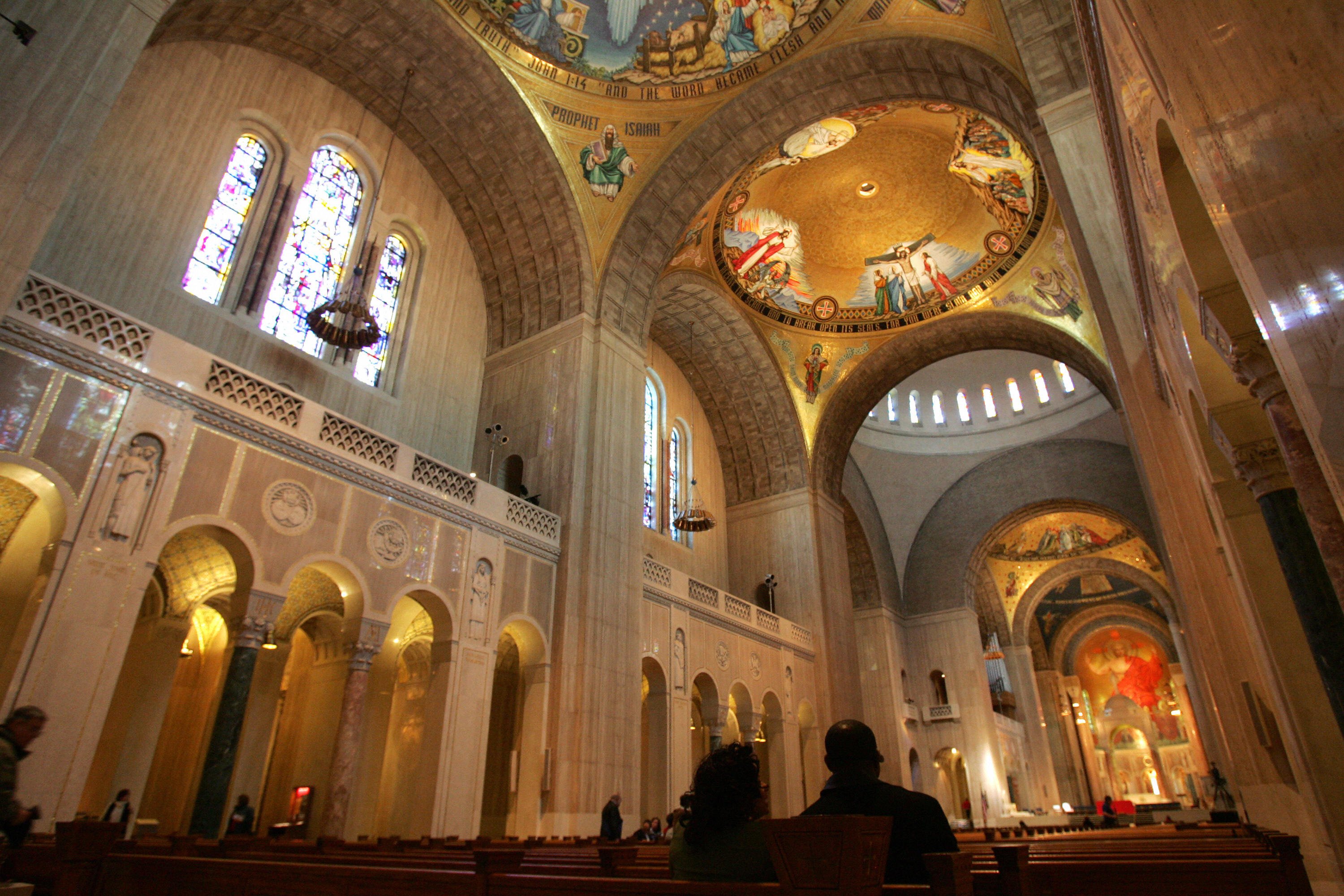 Visitors sit on pews in the Great Upper Church at the Basilica of the National Shrine of the Immaculate Conception on the campus of Catholic University in Washington, DC, on March 21, 2008. Pope Benedict XVI will hold a private prayer service and meeting with the 350 bishops of the United States at the Basilica as he makes his first official visit to the United States next month when he travels to New York and Washington, DC. AFP PHOTO/SAUL LOEB (Photo credit should read SAUL LOEB/AFP/Getty Images)