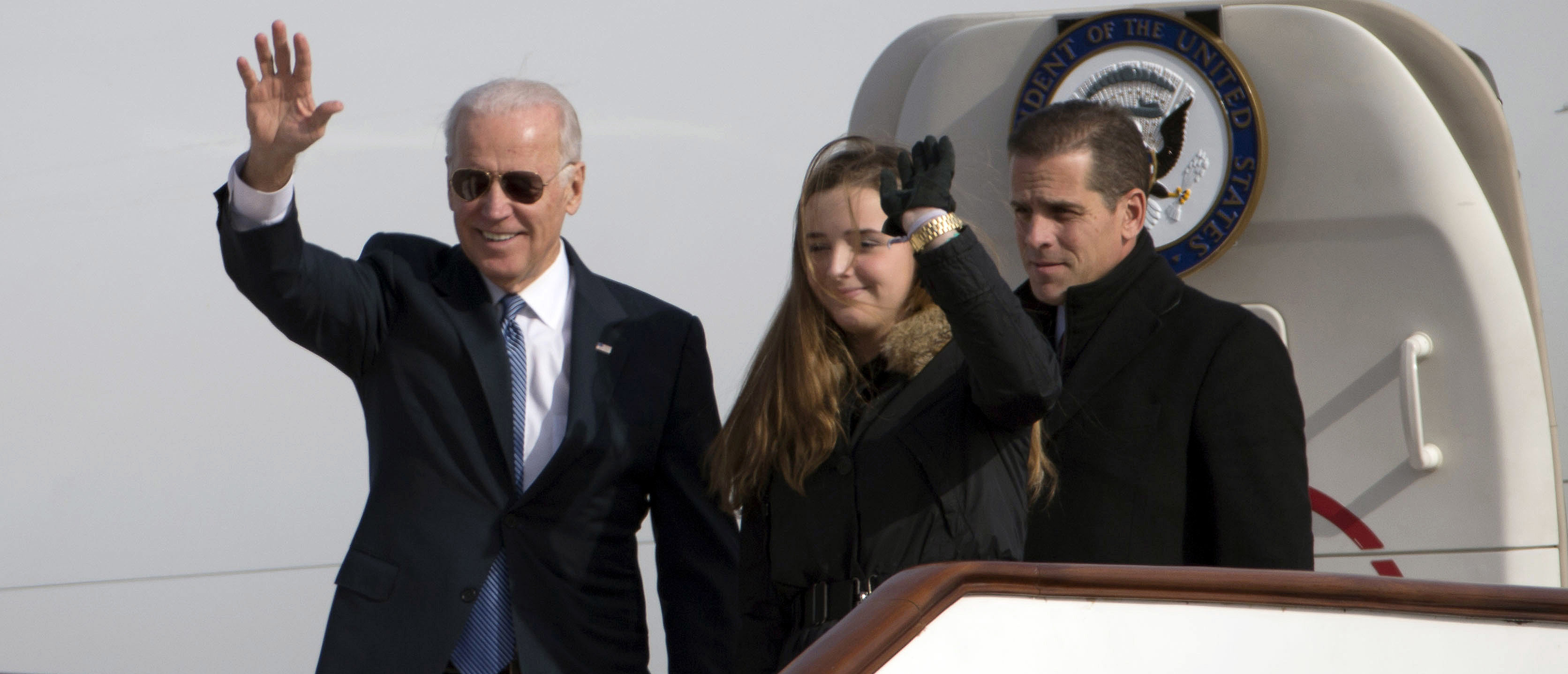 BEIJING, CHINA - DECEMBER 04: U.S. Vice President Joe Biden waves as he walks out of Air Force Two with his granddaughter Finnegan Biden and son Hunter Biden (R) on December 4, 2013 in Beijing, China. Biden is on the first leg of his week-long visit to Asia. (Photo by Ng Han Guan-Pool/Getty Images)
