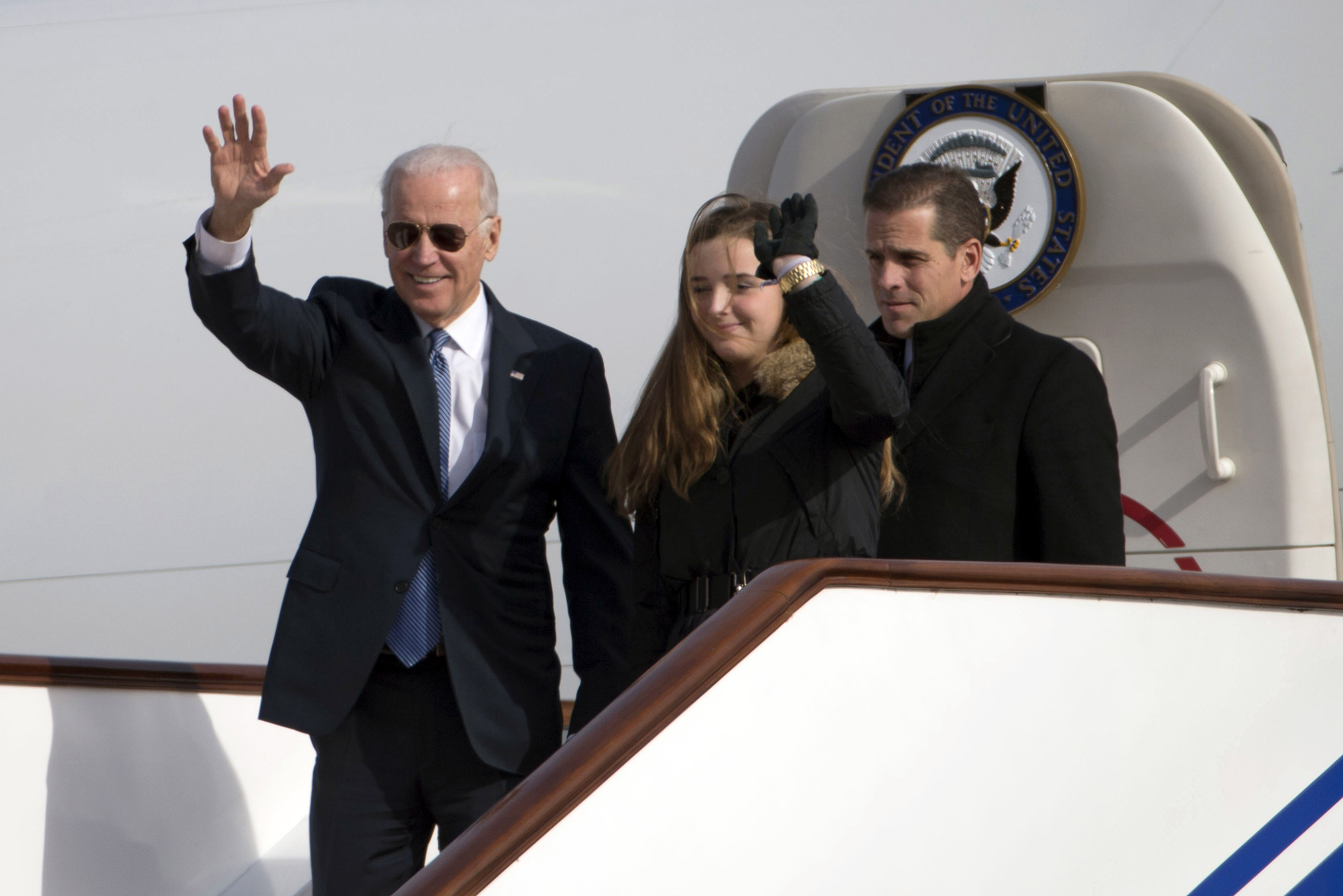 U.S. Vice President Joe Biden waves as he walks out of Air Force Two with his granddaughter Finnegan Biden and son Hunter Biden (R) on Dec. 4, 2013 in Beijing, China. (Photo by Ng Han Guan-Pool/Getty Images)
