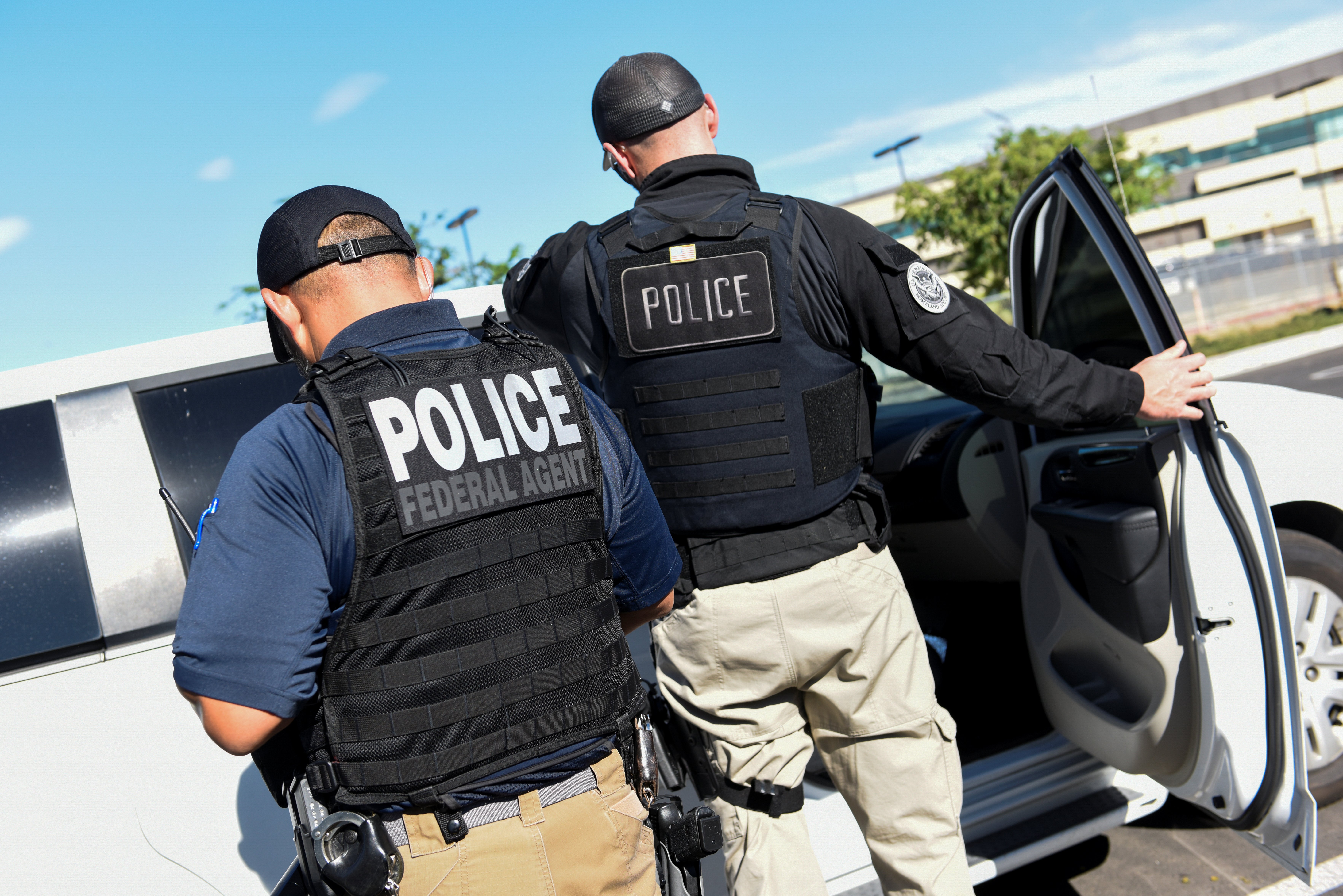 ICE Enforcement and Removal Operations (ERO) officers transfer an unauthorized immigrant with a criminal record during an Immigration and Customs Enforcement (ICE) operation in San Jose