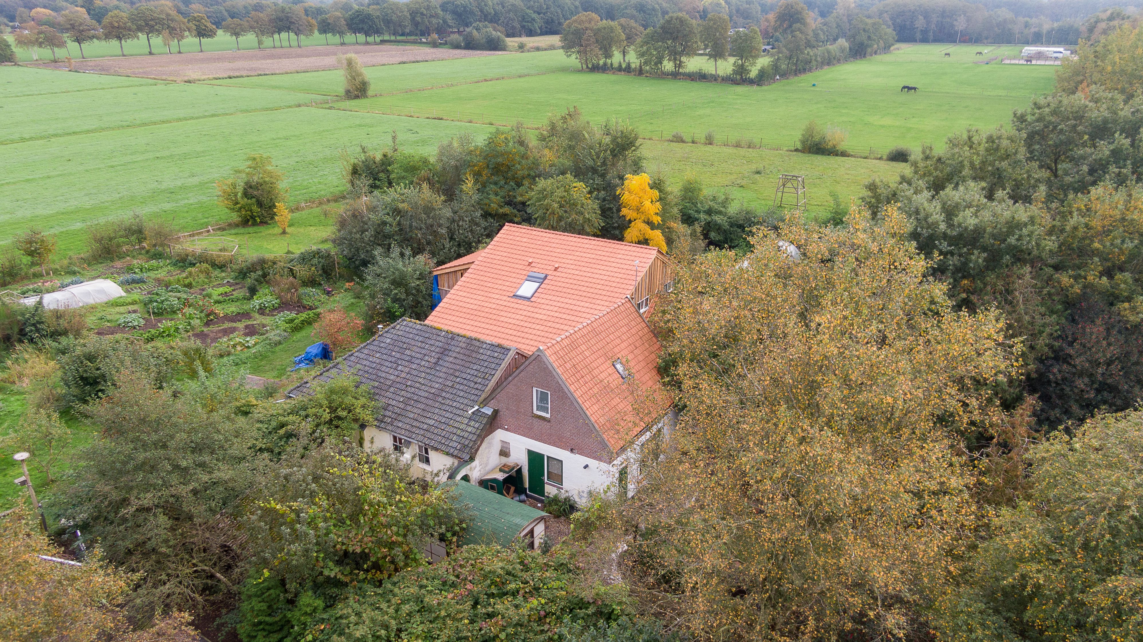 This aerial picture taken on October 15, 2019 shows a farmhouse in a remote area of northern Netherlands' province of Drenthe, near the village of Ruinerwold, where Dutch police discovered a hidden staircase behind a cupboard leading to a cellar where a man and five others believed to be his children aged between 18 and 25 were hidden and reportedly spent years "waiting for the end of time", officials said. - Local media said the family were found after one of the sons went to a nearby pub in a confused state, drank five beers and then asked for help, saying he had not been outside for nine years. Police arrested a 58-year-old man at the scene for failing to cooperate with the investigation, but he was not the father. Many questions were unanswered and police are investigating "All scenarios". "At this point we cannot give further information," local police said. (Photo by WILBERT BIJZITTER/ANP/AFP via Getty Images)