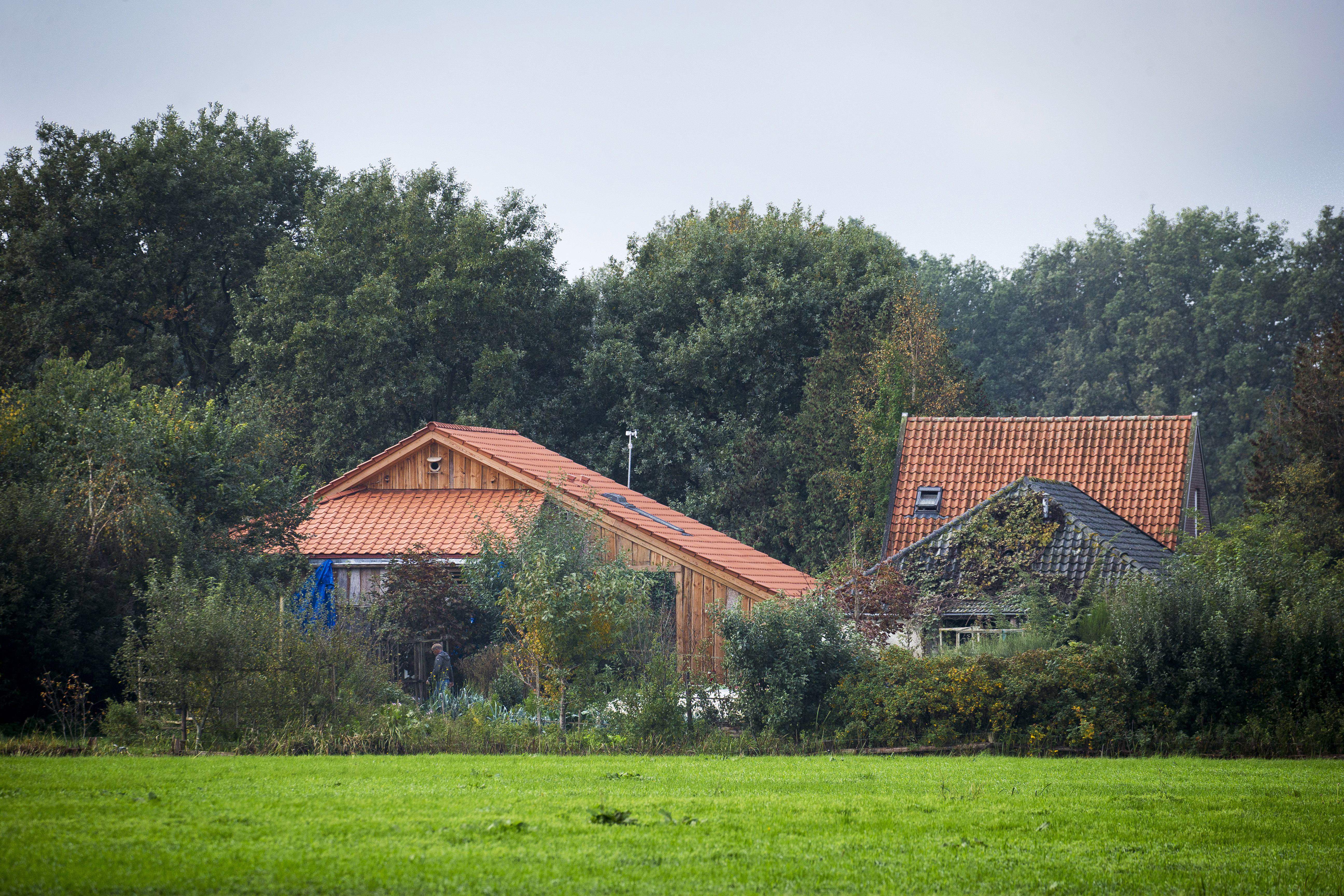 A plain clothes policeman inspects the farmhouse in a remote area of northern Netherlands' province of Drenthe, near the village of Ruinerwold, on October 16, 2019 a day after Dutch police discovered a hidden staircase behind a cupboard leading to a cellar where a man and five others believed to be his children aged between 18 and 25 were hidden and reportedly spent years "waiting for the end of time", officials said. - Local media said the family were found after one of the sons went to a nearby pub in a confused state, drank five beers and then asked for help, saying he had not been outside for nine years. Police arrested a 58-year-old man at the scene for failing to cooperate with the investigation, but he was not the father. Many questions were unanswered and police are investigating "All scenarios". "At this point we cannot give further information," local police said. (Photo by VINCENT JANNINK/ANP/AFP via Getty Images)