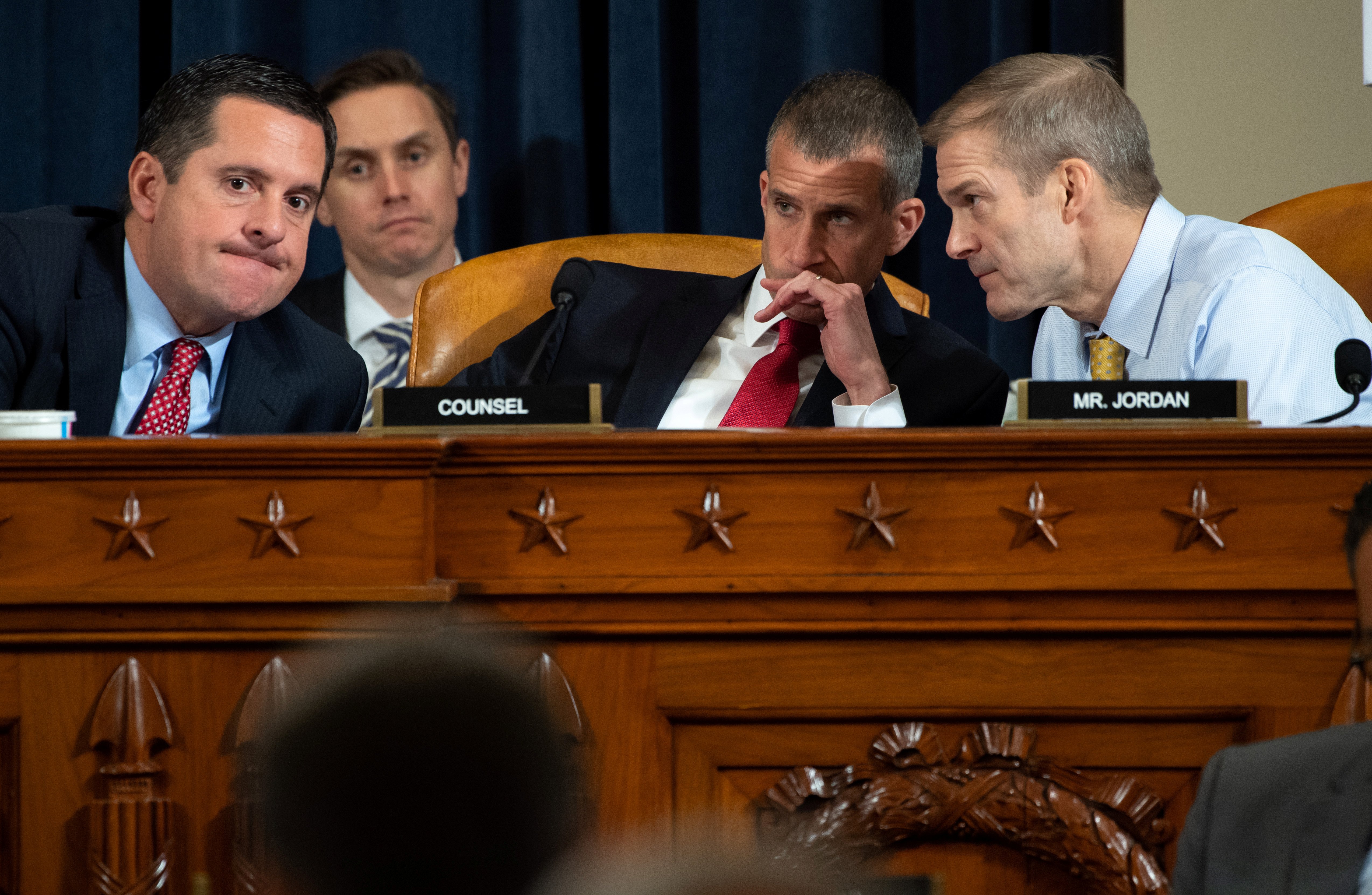Ranking Member Devin Nunes (L), Republican of California, speaks with Representative Jim Jordan (R), Republican of Ohio, and Republican Counsel Stephen Castor (C), during the first public hearings held by the House Permanent Select Committee on Intelligence as part of the impeachment inquiry into U.S. President Donald Trump, with witnesses Ukrainian Ambassador William Taylor and Deputy Assistant Secretary George Kent testifying, on Capitol Hill in Washington, DC, U.S., November 13, 2019. Saul Loeb/Pool via REUTERS