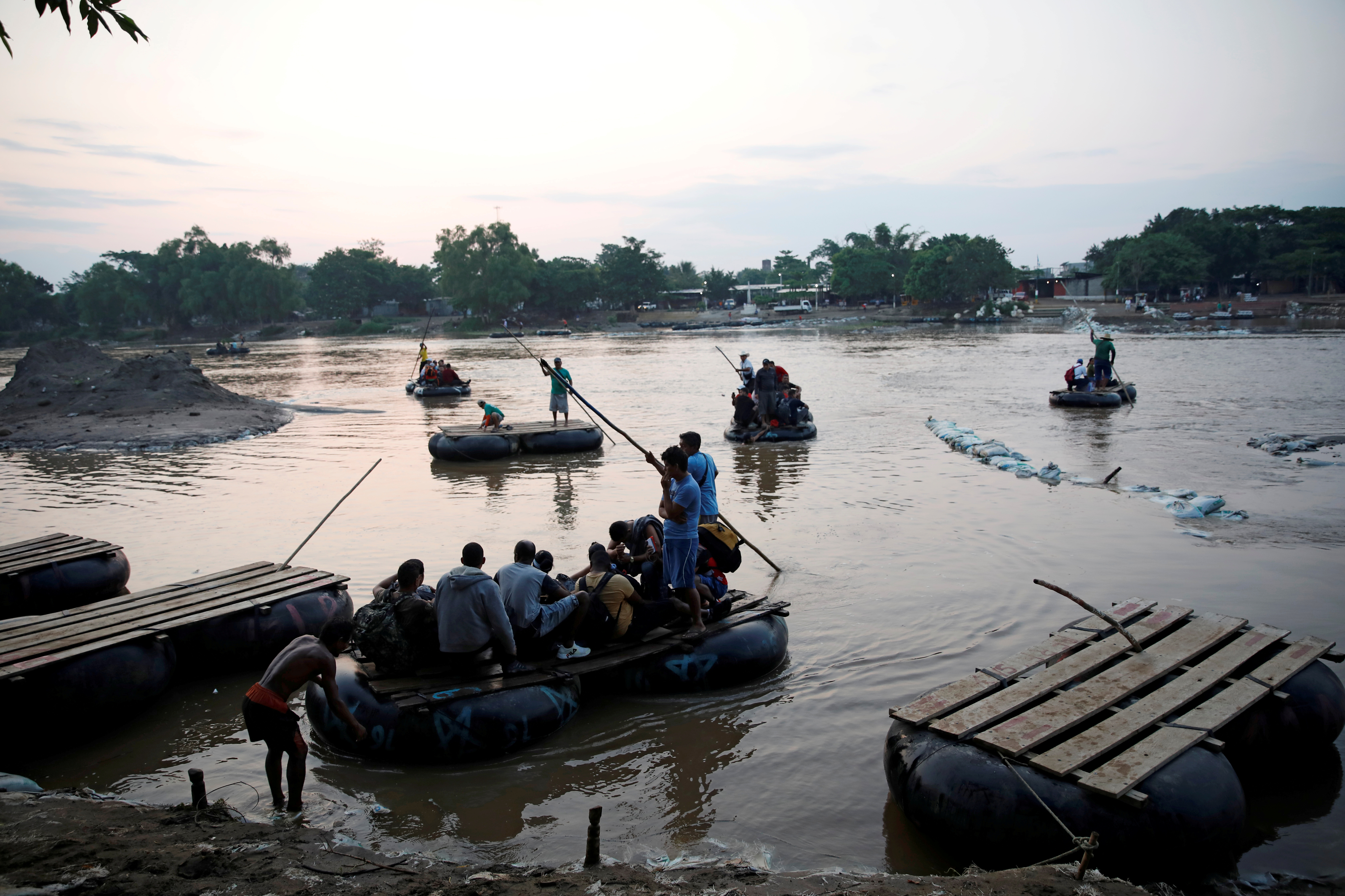 Cuban migrants cross the Suchiate river on rafts from Tecun Uman, in Guatemala, to Ciudad Hidalgo, as seen from Ciudad Hidalgo