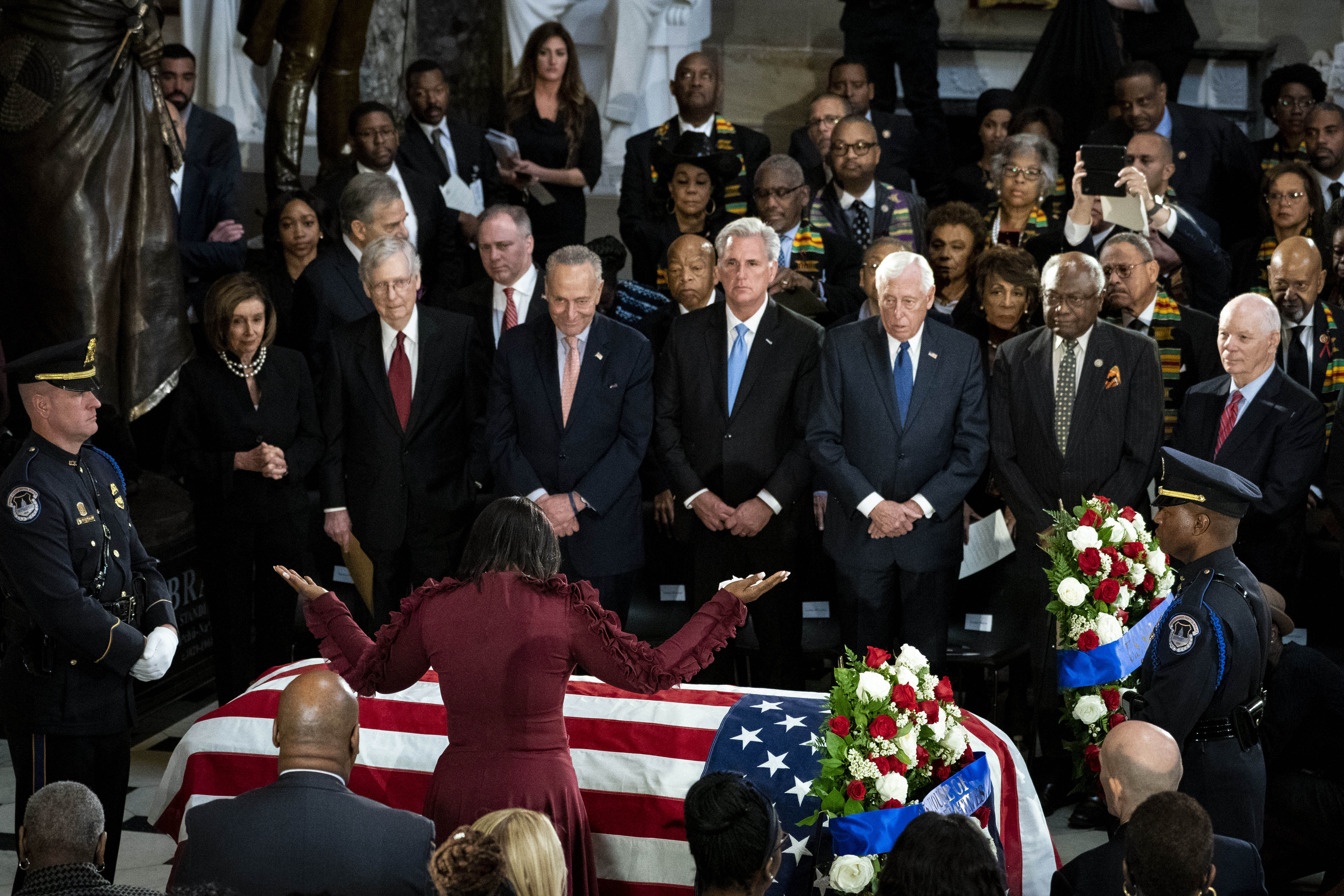 Maya Rockeymoore Cummings, widow of late Rep. Elijah Cummings (D-MD), raises her arms over his casket during a memorial service in National Statuary Hall at the U.S. Capitol October 24, 2019 in Washington, DC. (Photo by Al Drago-Pool/Getty Images)