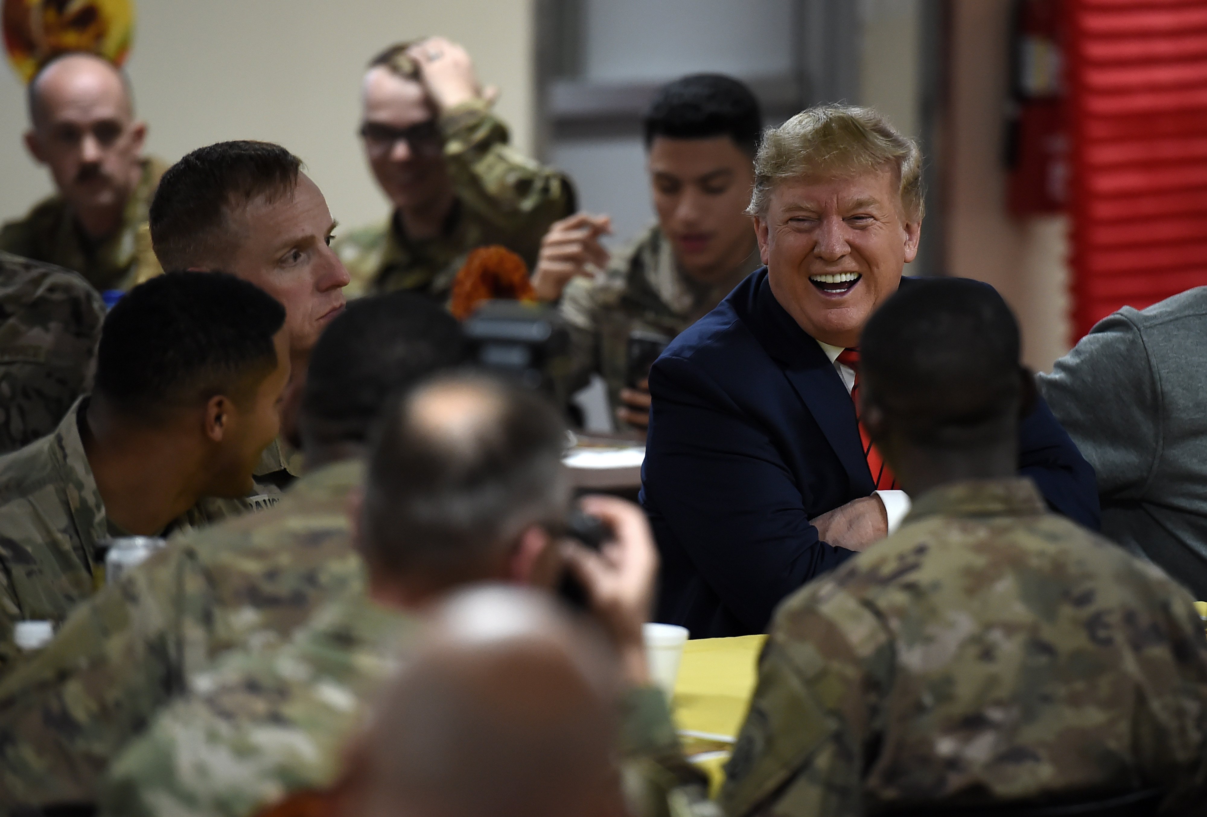 US President Donald Trump serves Thanksgiving dinner to US troops at Bagram Air Field during a surprise visit on November 28, 2019 in Afghanistan. (OLIVIER DOULIERY/AFP via Getty Images)