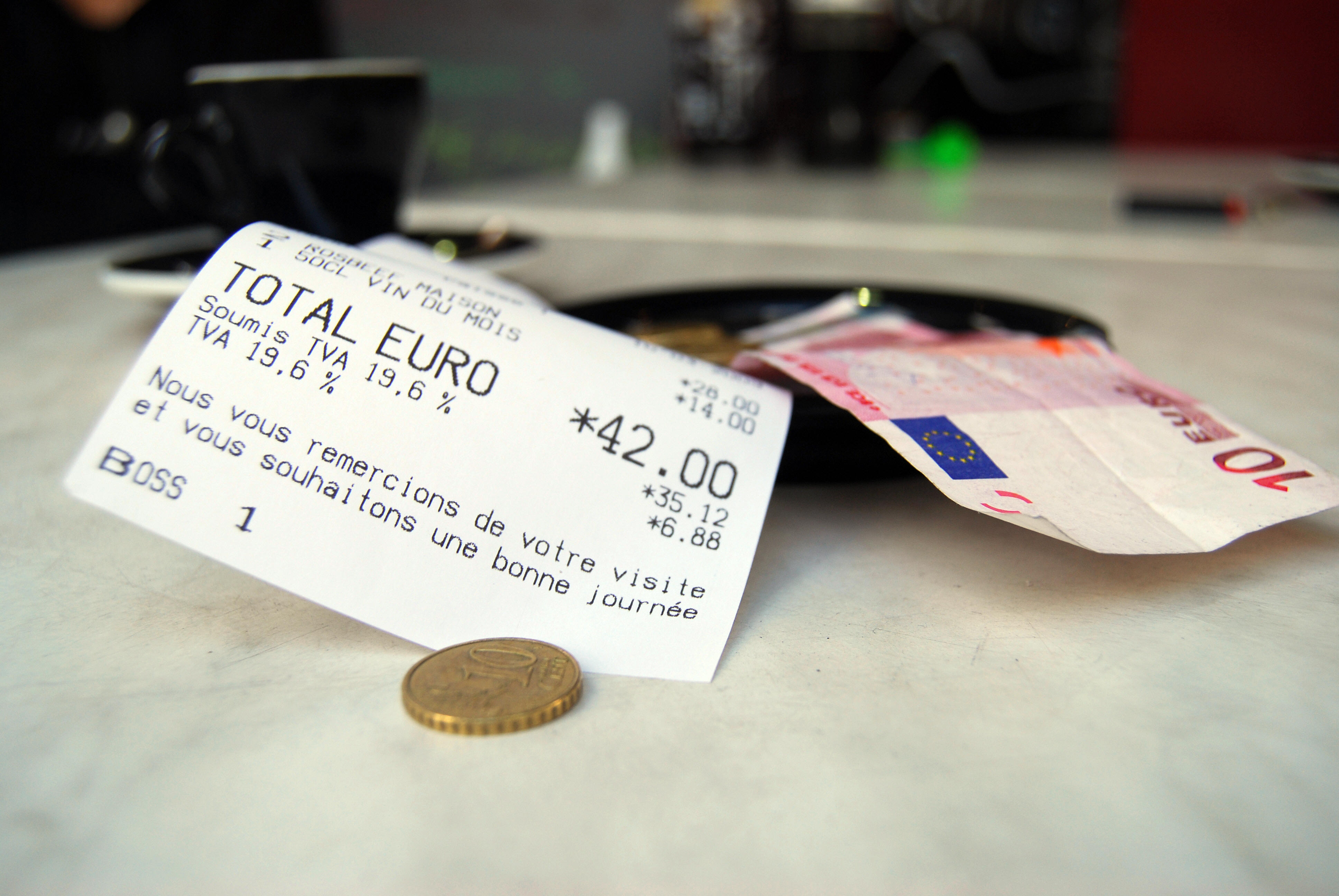 An invoice shows the 19.6 percent tax on a beverage at a restaurant in Paris on March 10, 2009. (Caroline VENTEZOU/AFP via Getty Images)