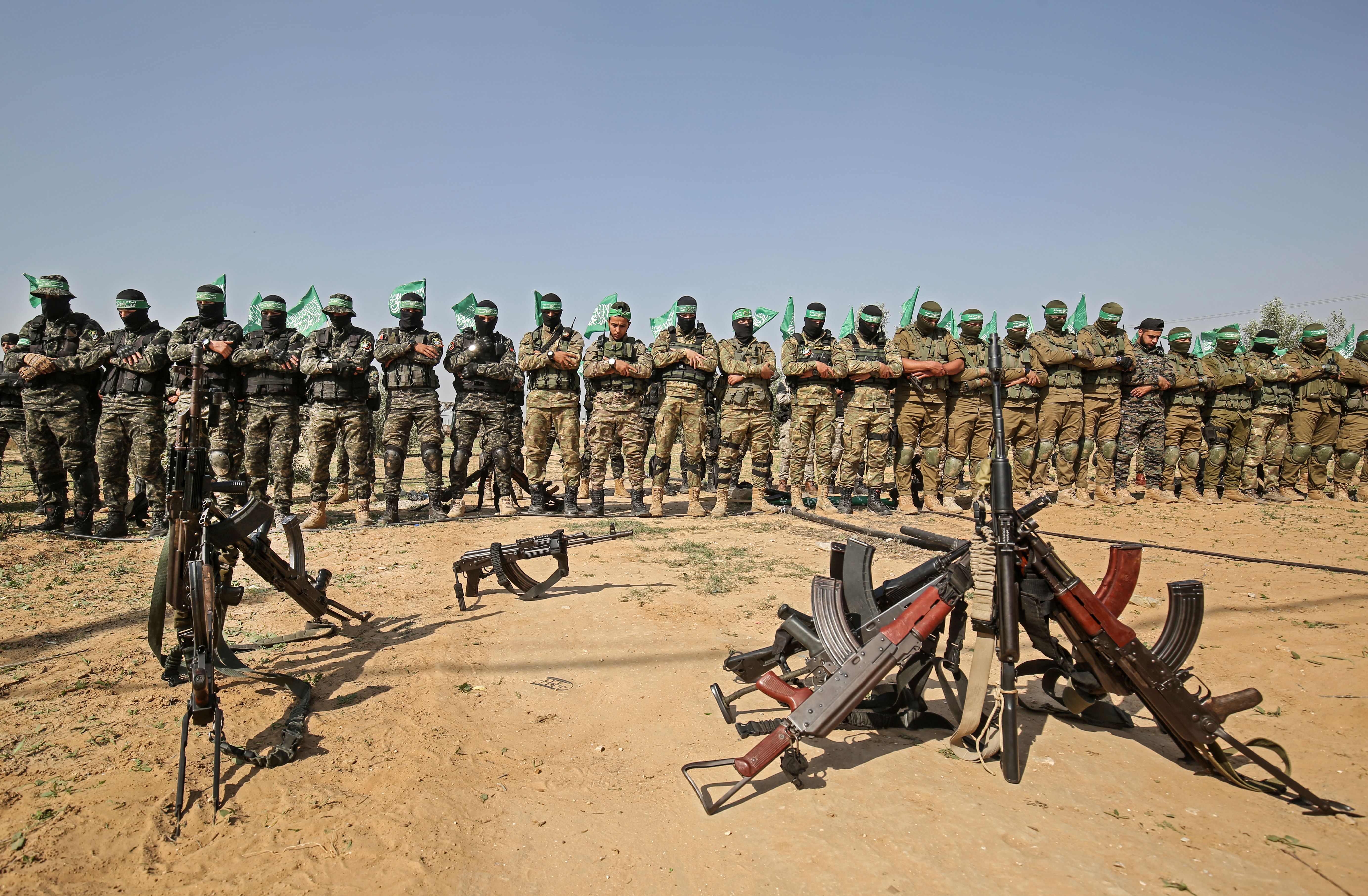 Fighters from the Ezz-Al Din Al-Qassam Brigades, the armed wing of the Palestinian Hamas movement, pray together during an anti-Israel military show in Khan Yunis in the southern Gaza Strip November 11, 2019 to mark one year since their comrade Nour Baraka, a commander in the group, was killed in an Israeli military operation in the Gaza Strip. (SAID KHATIB/AFP via Getty Images)