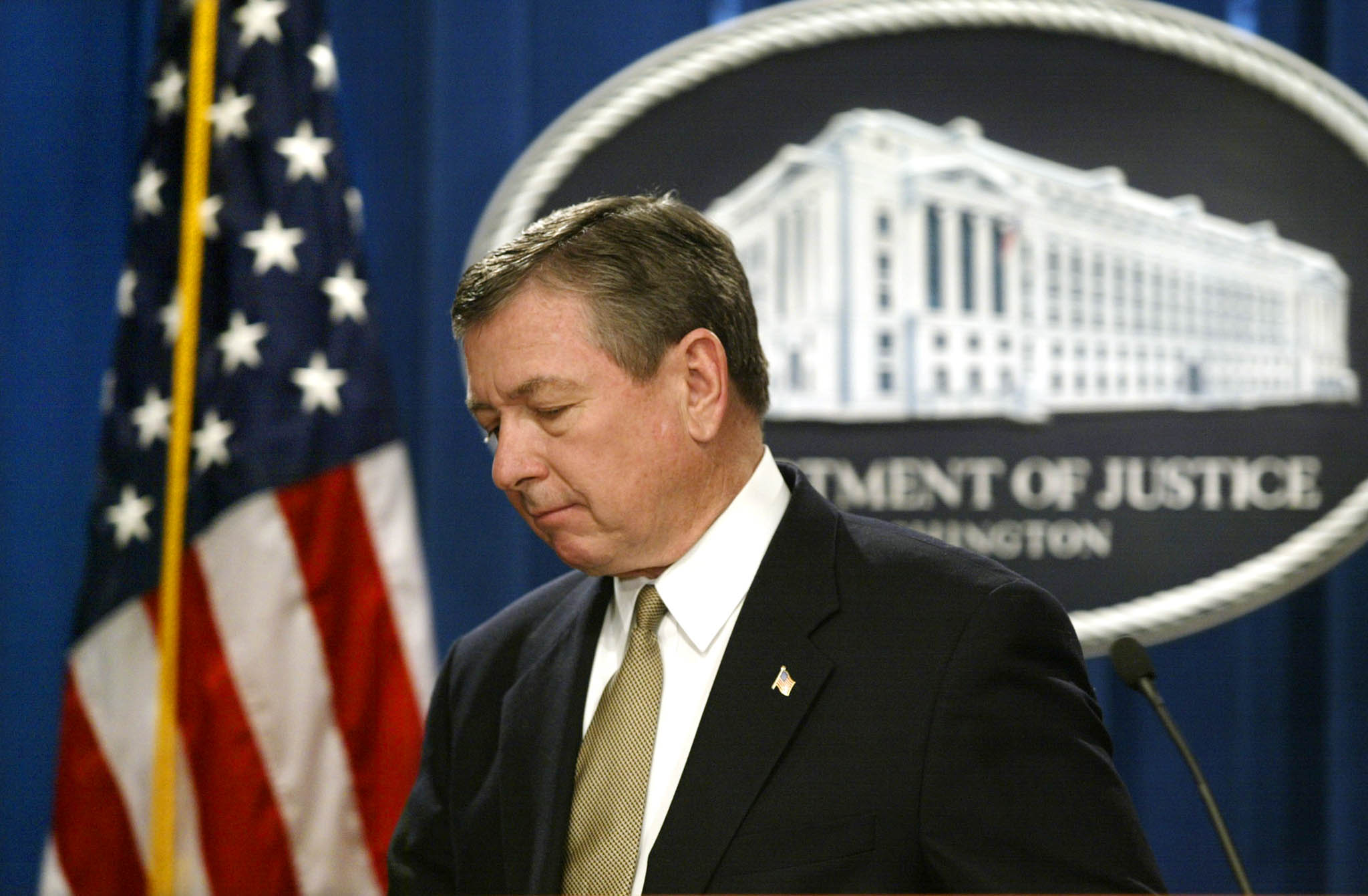 U.S. Attorney General John Ashcroft leaves the conference room at the Justice Department after addressing the media on new measures to protect children after the Supreme Court today struck down a law banning virtual child pornography, April 16, 2002. The court ruled against Ashcroft and said that the First Amendment protects pornography or other images that only appear to depict real children engaged in sex. REUTERS/Kevin Lamarque