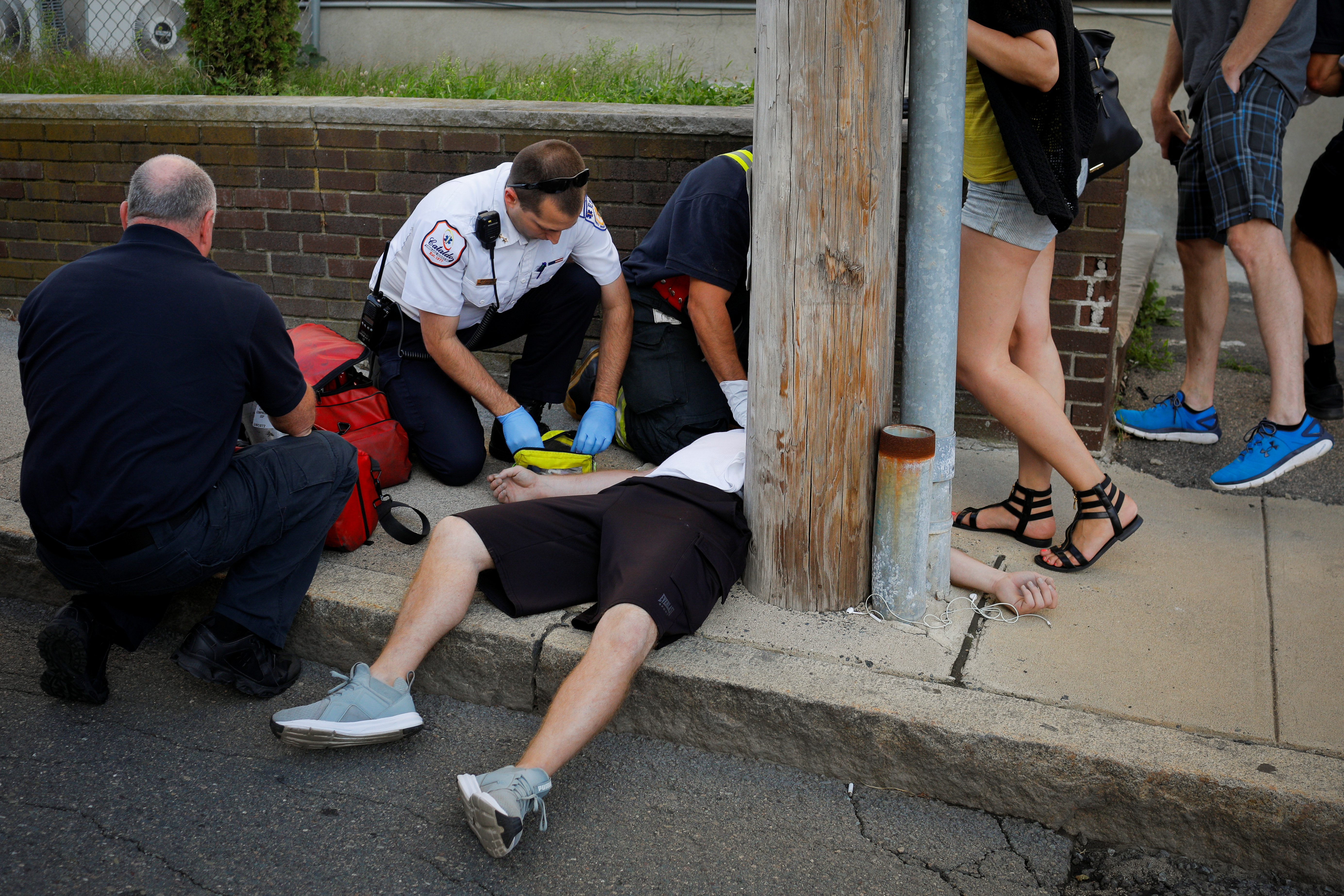 Cataldo Ambulance medics and other first responders revive a 32-year-old man who was found unresponsive and not breathing after an opioid overdose on a sidewalk in the Boston suburb of Everett, Massachusetts. (REUTERS/Brian Snyder)