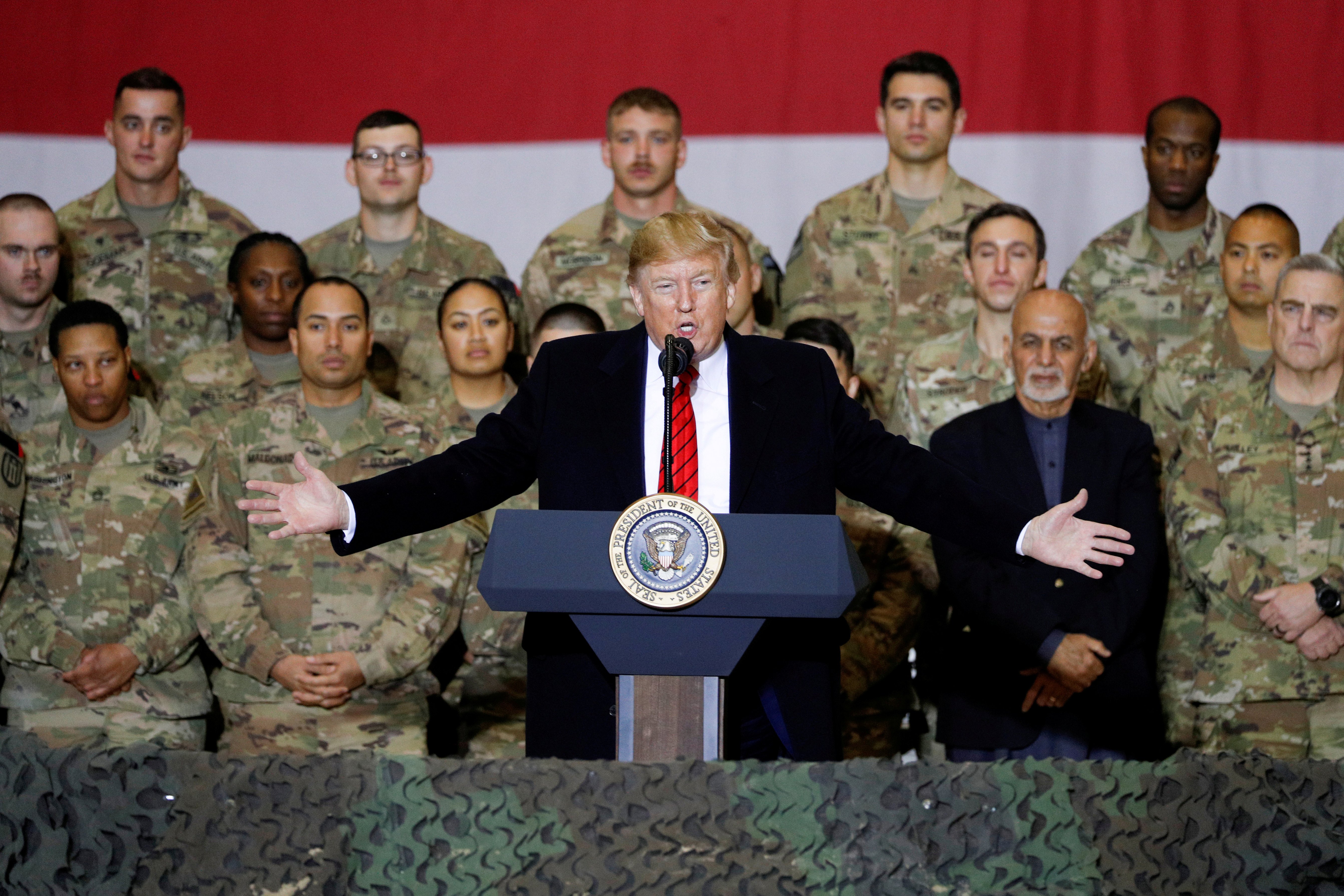 U.S. President Donald Trump delivers remarks to U.S. troops, with Afghanistan President Ashraf Ghani standing behind him, during an unannounced visit to Bagram Air Base, Afghanistan, November 28, 2019. REUTERS/Tom Brenner 