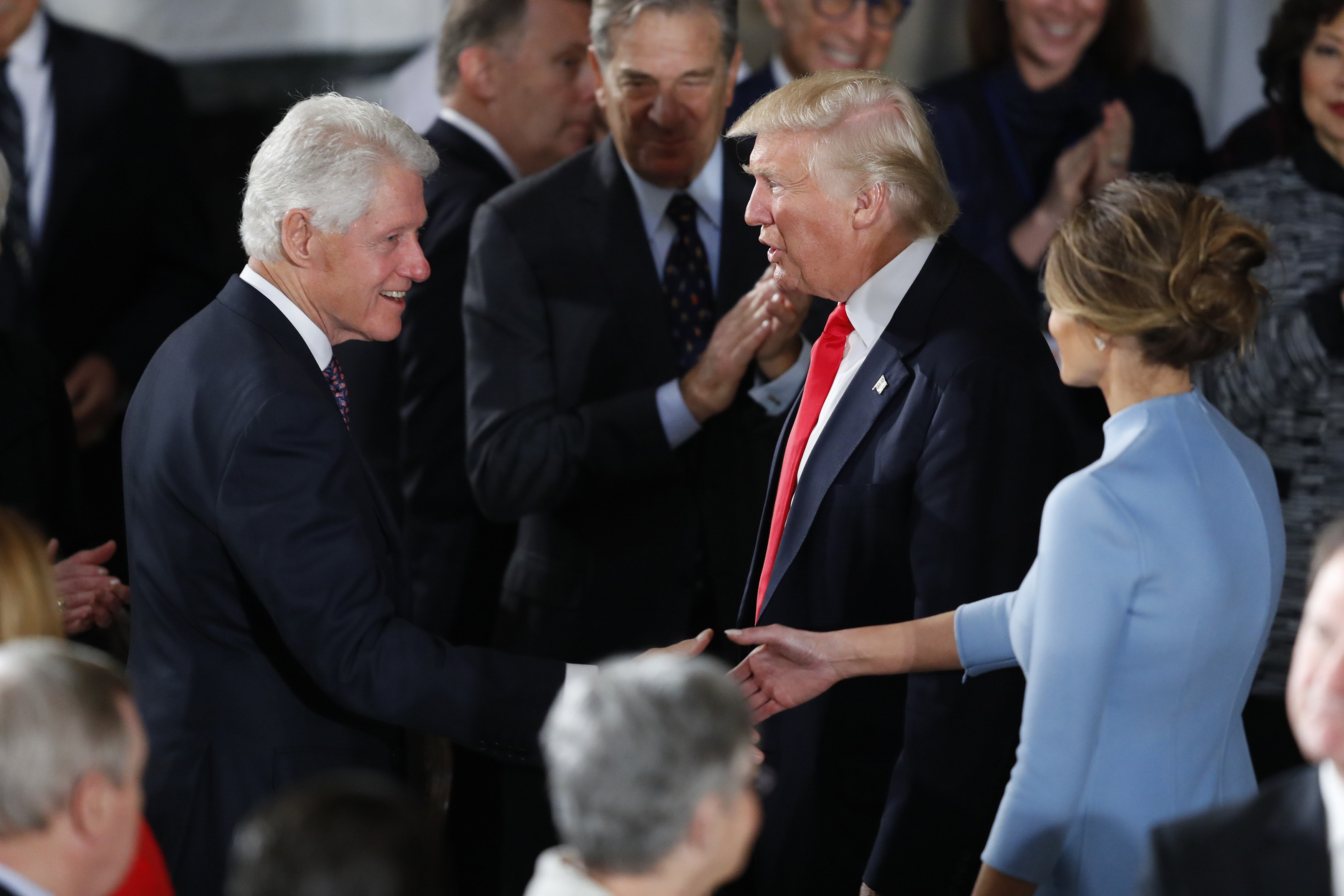 President Donald Trump and first lady Melania Trump greet former President Bill Clinton at the Inaugural Luncheon in the US Capitol January 20, 2017 in Washington, DC. President Trump will attend the luncheon along with other dignitaries after being sworn in as the 45th President of the United States. (Photo by Aaron P. Bernstein/Getty Images)
