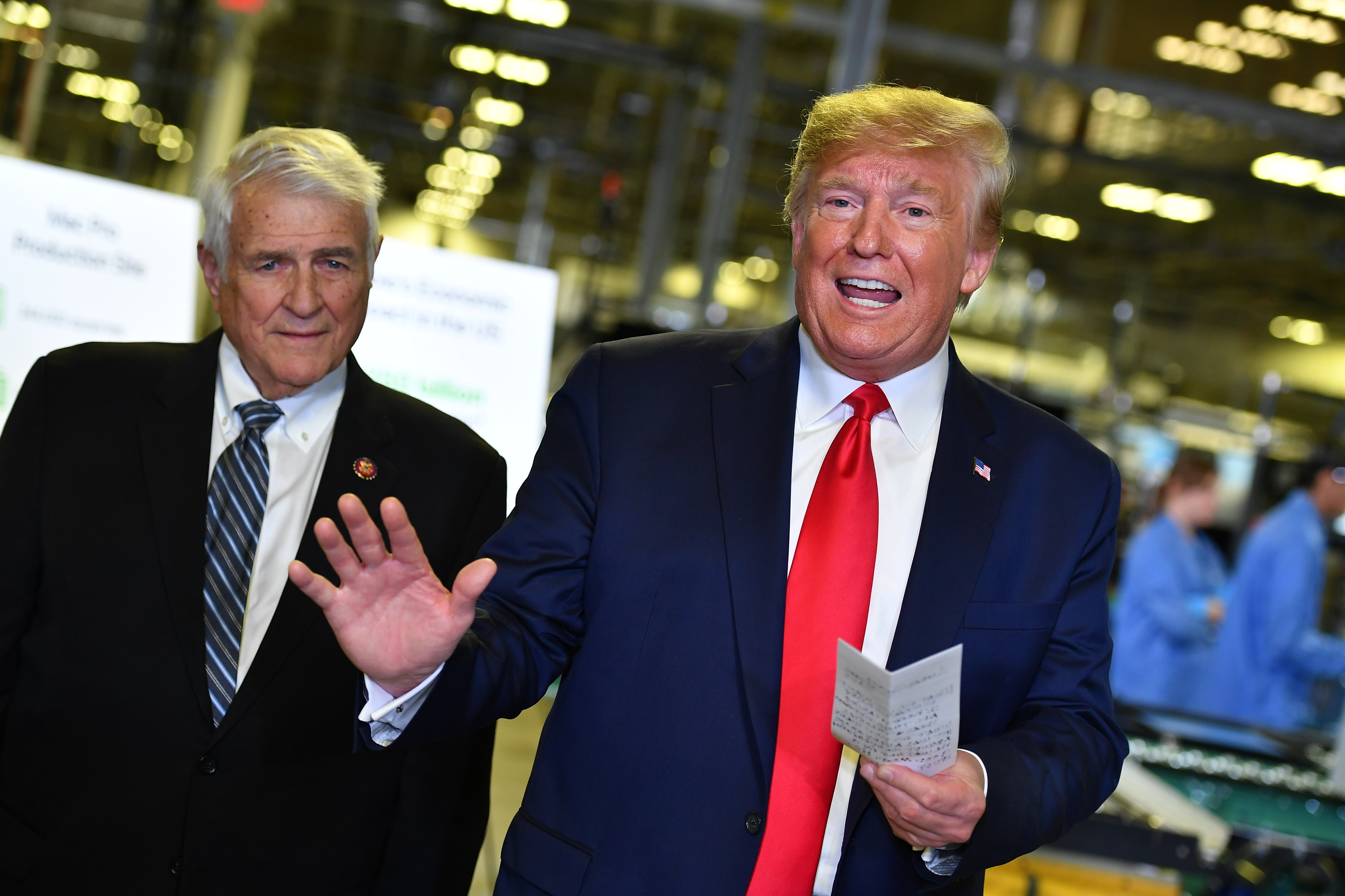 US President Donald Trump, with US Republican Representative from Texas John Carter (L), speaks about the impeachment inquiry during a tour of the Flextronics computer manufacturing facility where Apple's Mac Pros are assembled in Austin, Texas, on November 20, 2019. (Photo by MANDEL NGAN / AFP) / The erroneous mention[s] appearing in the metadata of this photo by MANDEL NGAN has been modified in AFP systems in the following manner: [John Carter] instead of [John Cater]. Please immediately remove the erroneous mention[s] from all your online services and delete it (them) from your servers. If you have been authorized by AFP to distribute it (them) to third parties, please ensure that the same actions are carried out by them. Failure to promptly comply with these instructions will entail liability on your part for any continued or post notification usage. Therefore we thank you very much for all your attention and prompt action. We are sorry for the inconvenience this notification may cause and remain at your disposal for any further information you may require. (Photo by MANDEL NGAN/AFP via Getty Images)