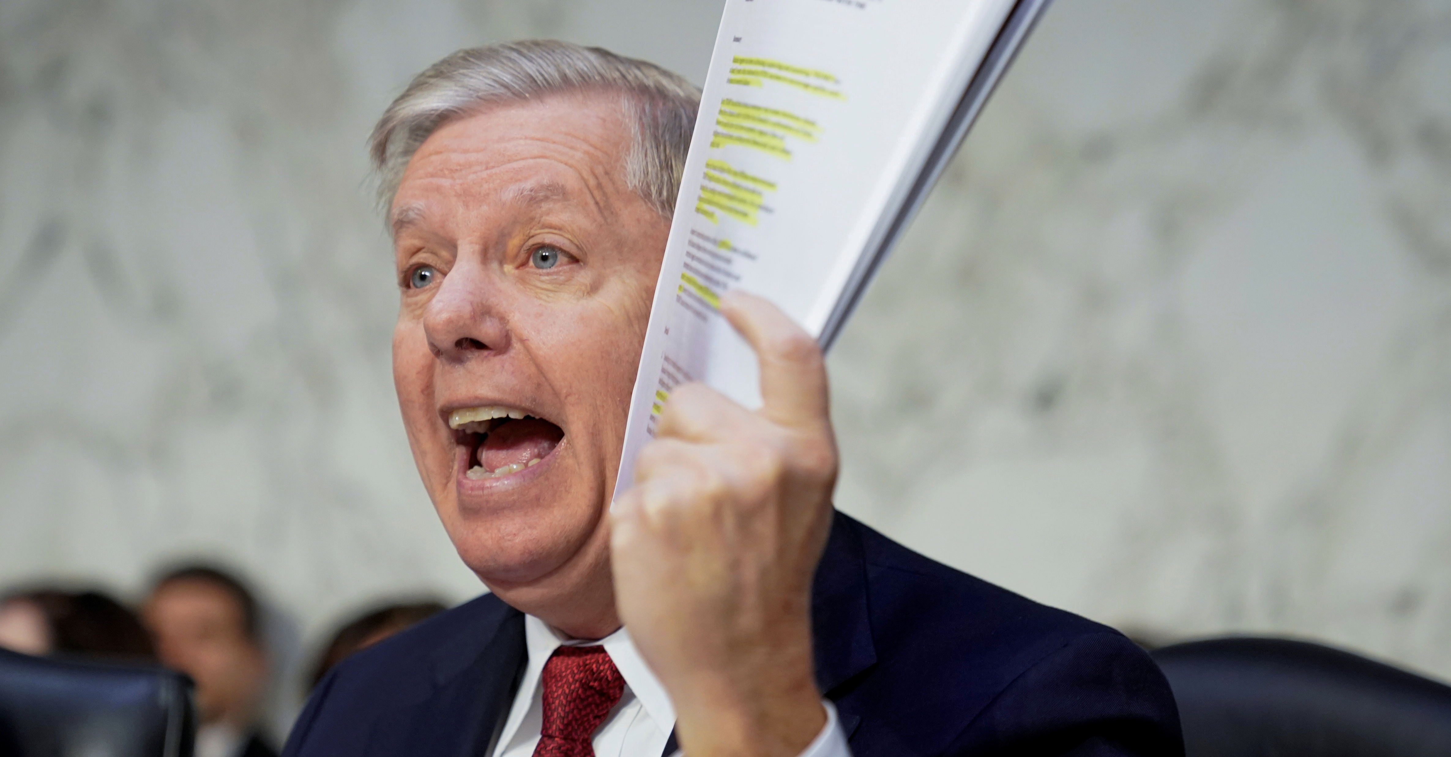 U.S. Senate Judiciary Committee Chairman Senator Lindsey Graham (R-SC) holds a copy of an intelligence report on the Steele dossier as he delivers an opening statement prior to hearing testimony from Justice Department Inspector General Michael Horowitz before a Senate Judiciary Committee hearing "Examining the Inspector General's report on alleged abuses of the Foreign Intelligence Surveillance Act (FISA)" on Capitol Hill in Washington, U.S., December 11, 2019. REUTERS/Joshua Roberts -