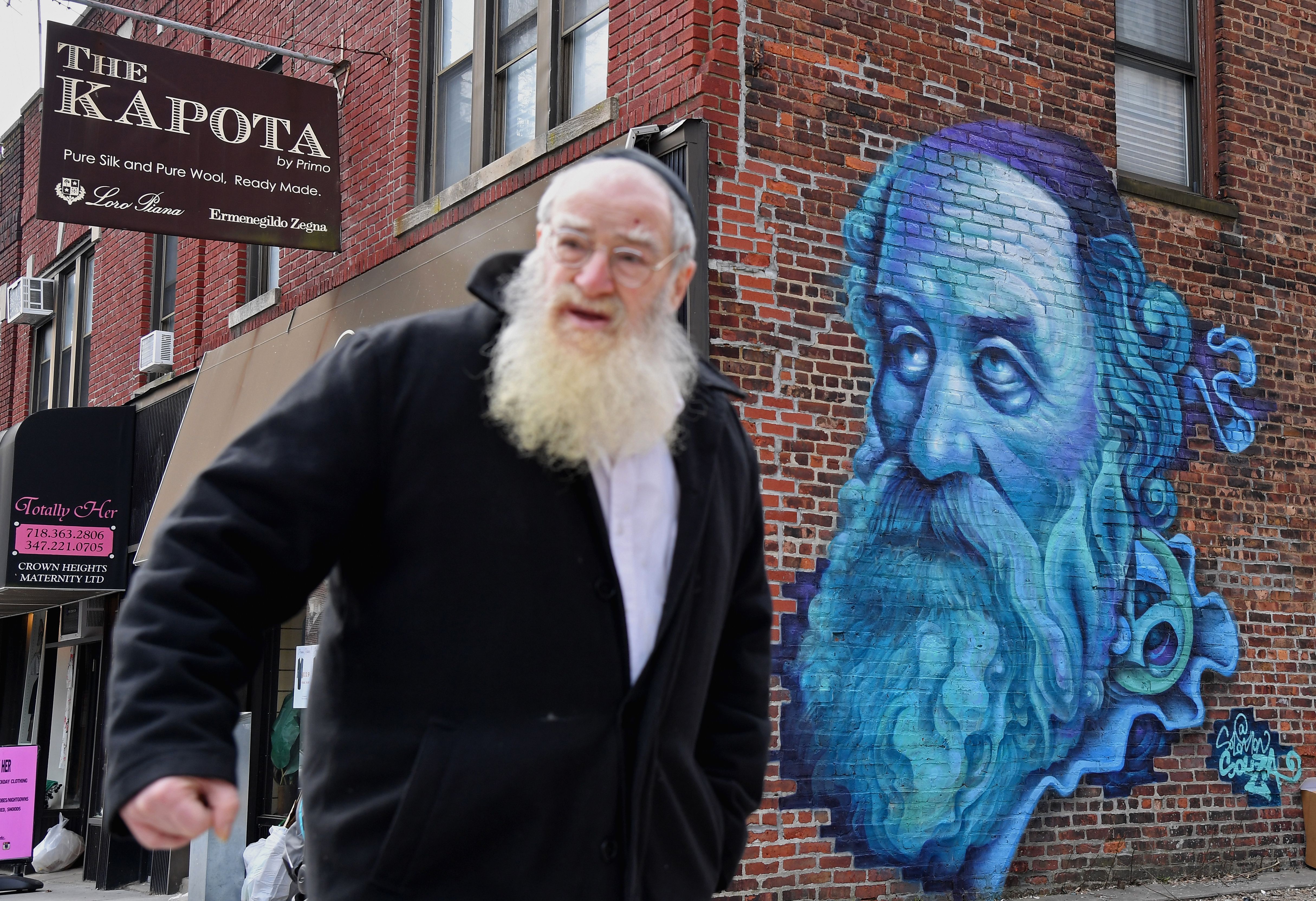 An Orthodox Jewish man walks past a mural of Alter Rebbe, the founder of Chabad Chassidus, by graffiti artist Salomon Souza in the Brooklyn neighborhood of Crown Heights on February 27, 2019 in New York. - Crown Heights has experienced a surge in antisemitic attacks over the last months, all aimed at members of the Hasidic community. (Photo: ANGELA WEISS/AFP via Getty Images)
