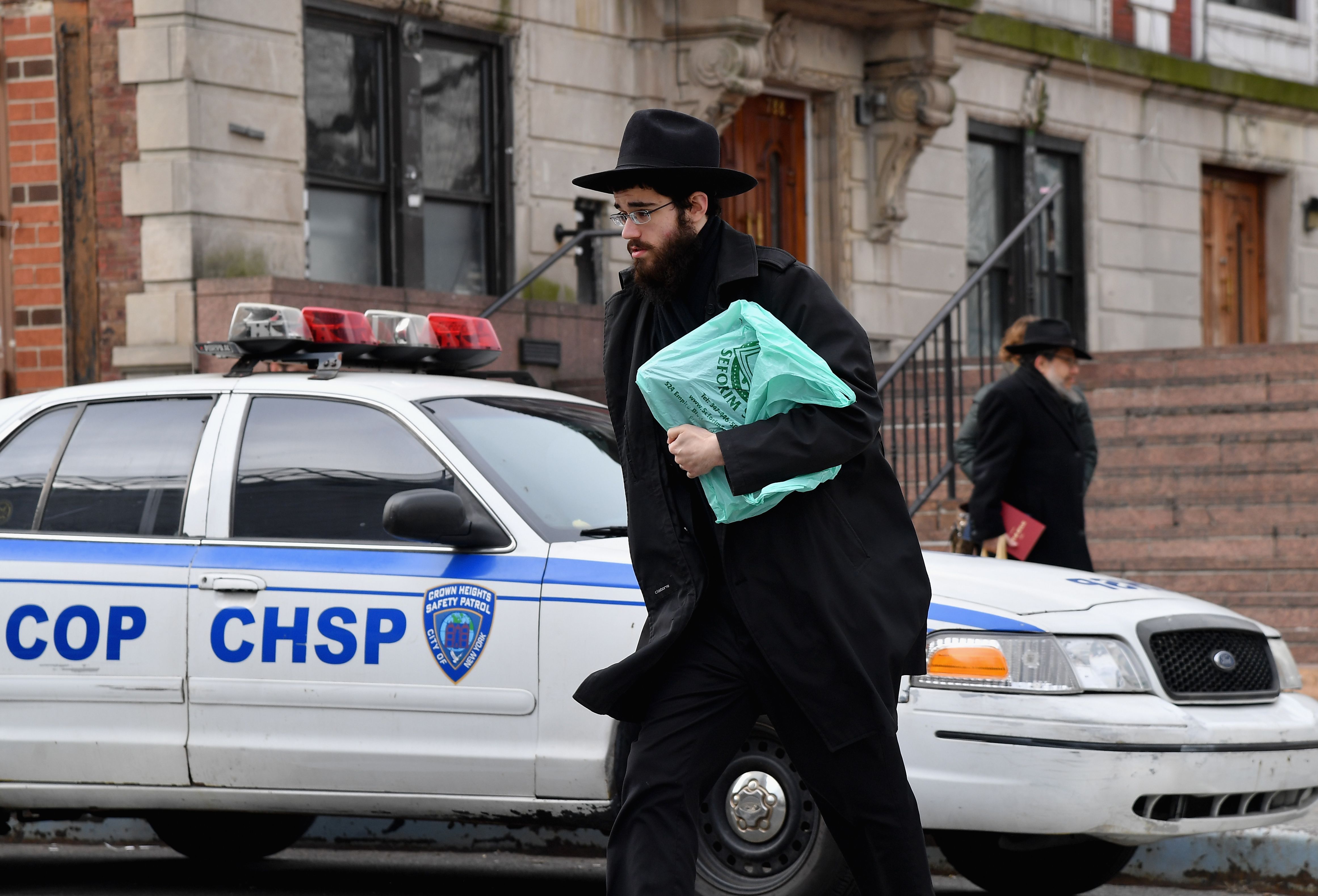 Orthodox Jewish men walks in the Brooklyn neighborhood of Crown Heights on February 27, 2019 in New York. - Residents of Crown Heights, a diverse New York neighborhood far from Manhattan's skyscrapers, are trying to understand a spate of anti-Semitic attacks that has brought back painful memories. In recent months, several people wearing the type of black clothing and hats associated with the Orthodox Jewish community have been viciously assaulted -- sometimes in broad daylight. So far this year, complaints of anti-Semitic crimes have soared by 71 percent in New York, compounding a 23 percent increase in 2018 (Photo: ANGELA WEISS/AFP via Getty Images)