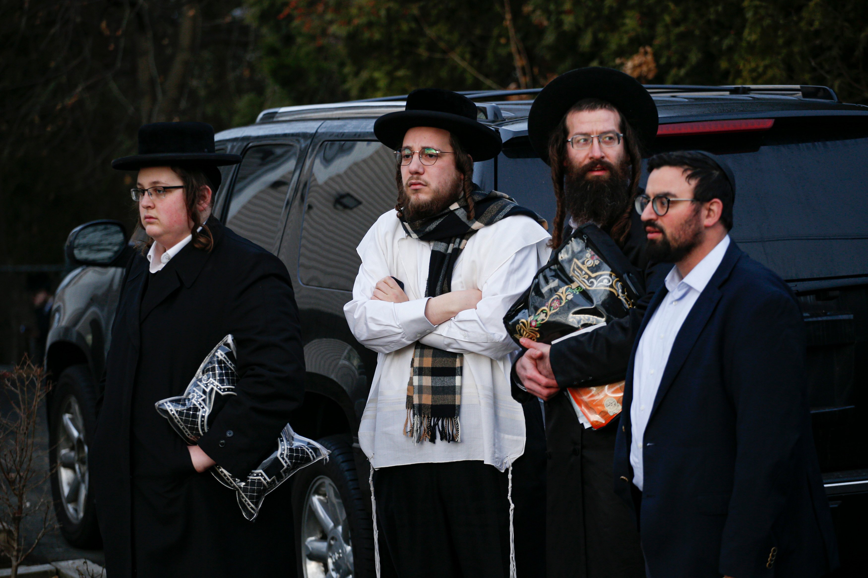 Members of the Jewish community gather outside the home of rabbi Chaim Rottenbergin Monsey, in New York on December 29, 2019. (KENA BETANCUR/AFP via Getty Images)