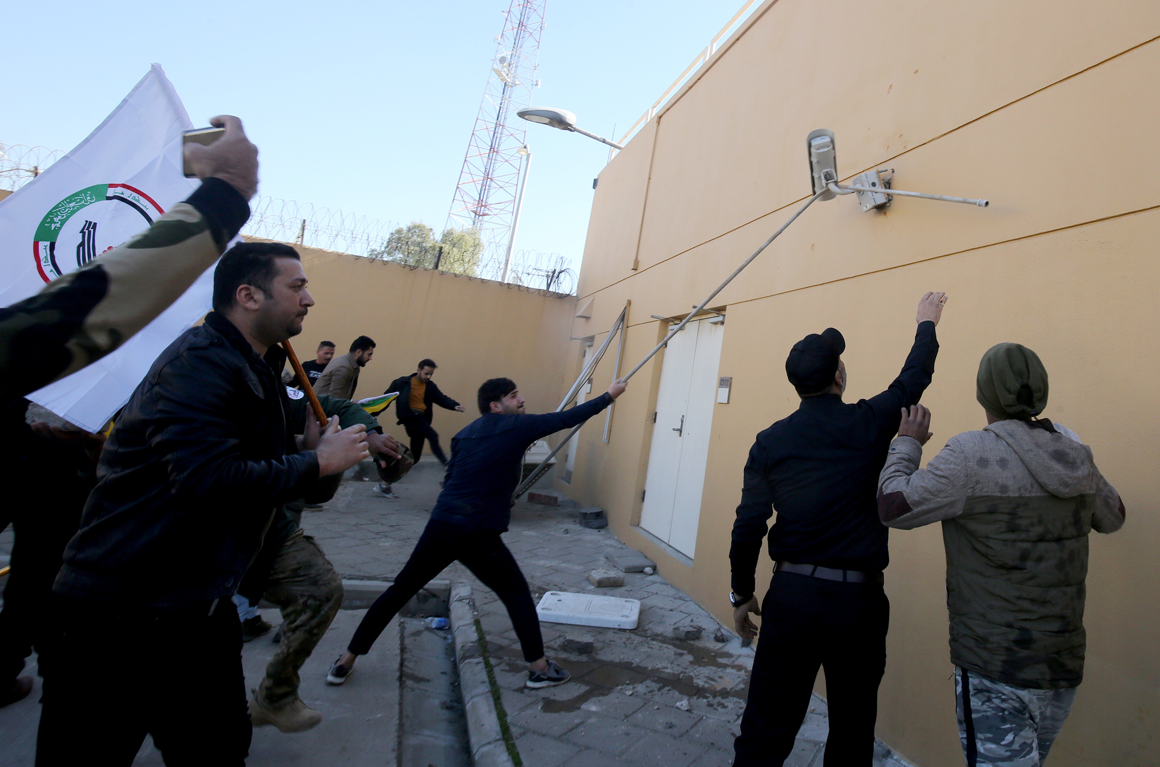 Iraqi protesters breach the outer wall of the US embassy in Baghdad during an angry demonstration on December 31, 2019 to denounce weekend US air strikes that killed Iran-backed fighters in Iraq. (AHMAD AL-RUBAYE/AFP via Getty Images)