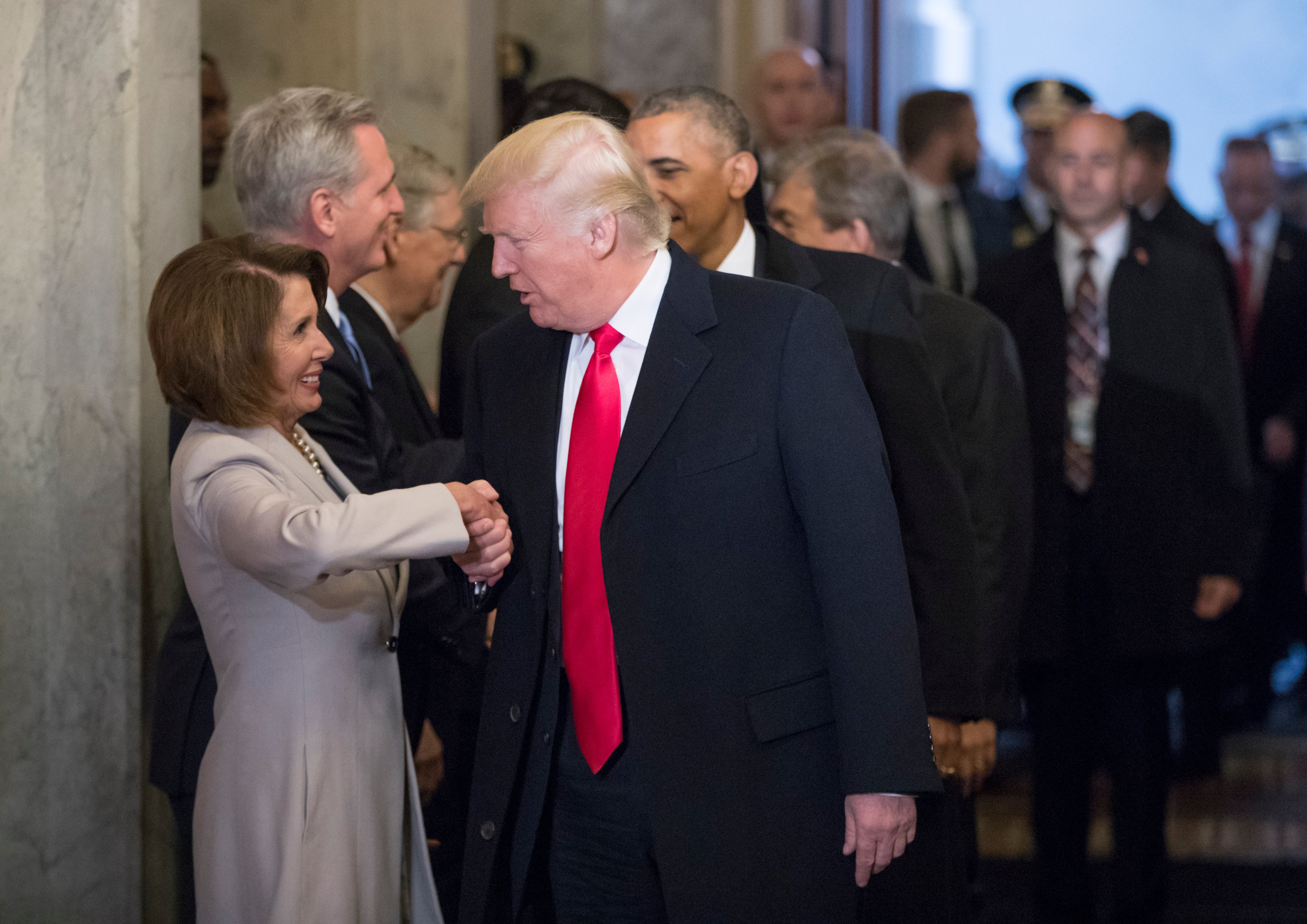 WASHINGTON, DC - JANUARY 20: President-elect Donald Trump (C) and President Barack Obama (R) are greeted by members of the Congressional leadership including House Minority Leader Nancy Pelosi (D-CA) as they arrive for Trump's inauguration ceremony at the Capitol on January 20, 2017 in Washington, DC. Trump became the 45th president of the United States. (Photo by J. Scott Applewhite - Pool/Getty Images)