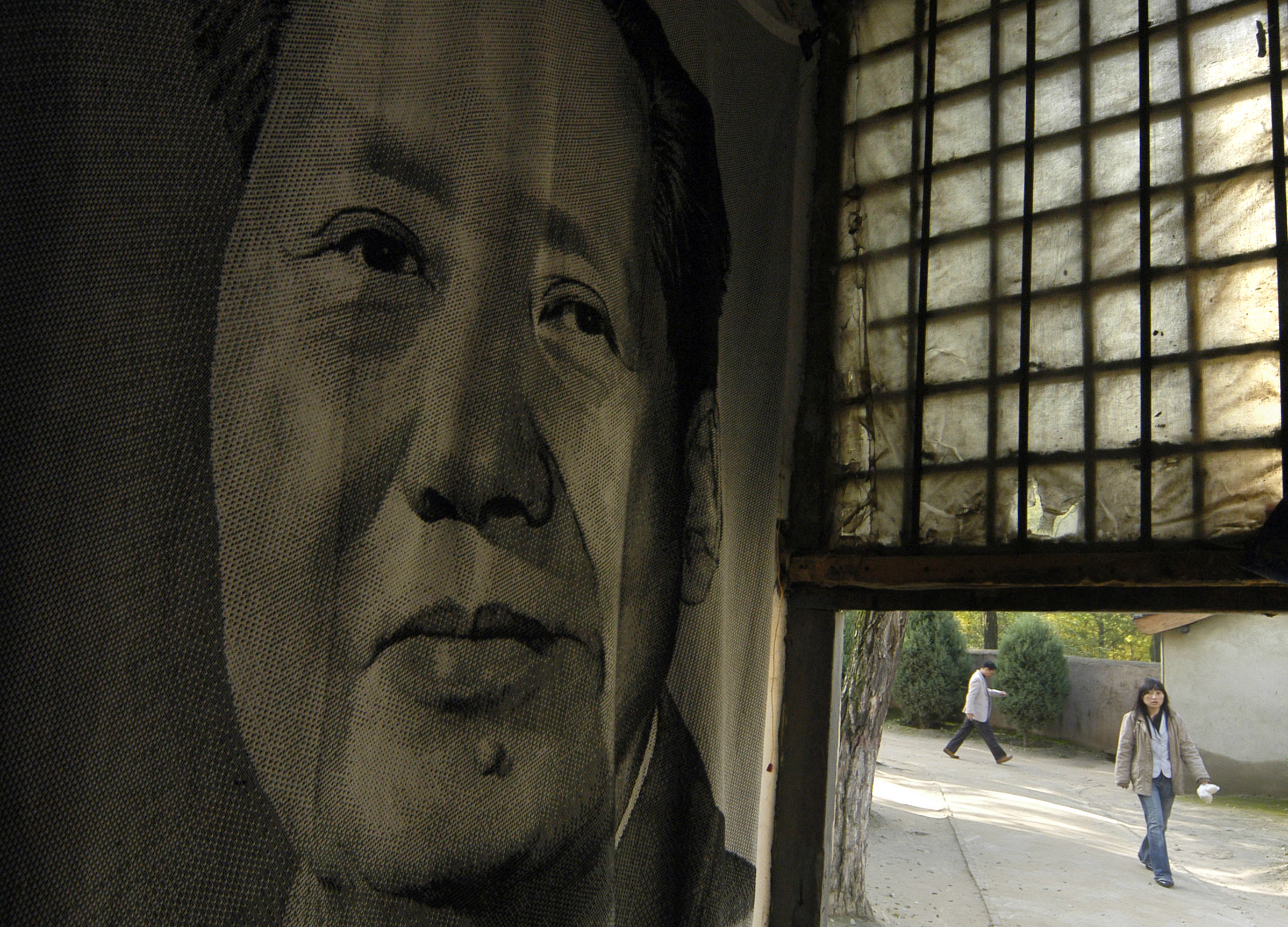 A portrait of Chinese leader Mao Zedong is seen inside a shop in Yan'an, northwest China's Shaanxi province October 15, 2007. Yan'an was a dusty but secure home to Mao from 1935 to 1947 and where he coined the motto "serve the people" and welded his party into a fighting force capable of winning the civil war. The caves that sheltered Mao and his Communists from attacking Japanese and Chinese enemies in the 1930s are now museums, but many residents of this loess plateau region still prefer the comfort of a cave. REUTERS/Stringer (CHINA)
