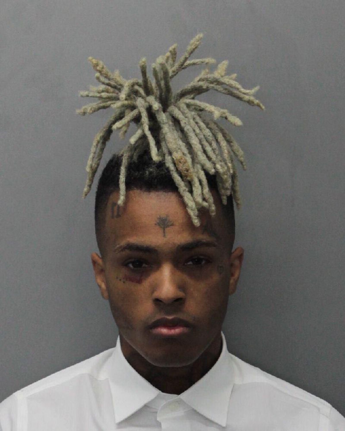 DECEMBER 15: In this handout provided by the Miami Dade County Corrections, Rapper XXXTentacion, also known as Jahseh Dwayne Onfroy poses for his mugshot after being charged with seven new felonies stemming from a 2016 domestic violence case on December 15, 2017 in Miami, Florida. The new charges are for witness tampering and harassment. (Photo by Miami Dade County Corrections via Getty Images)