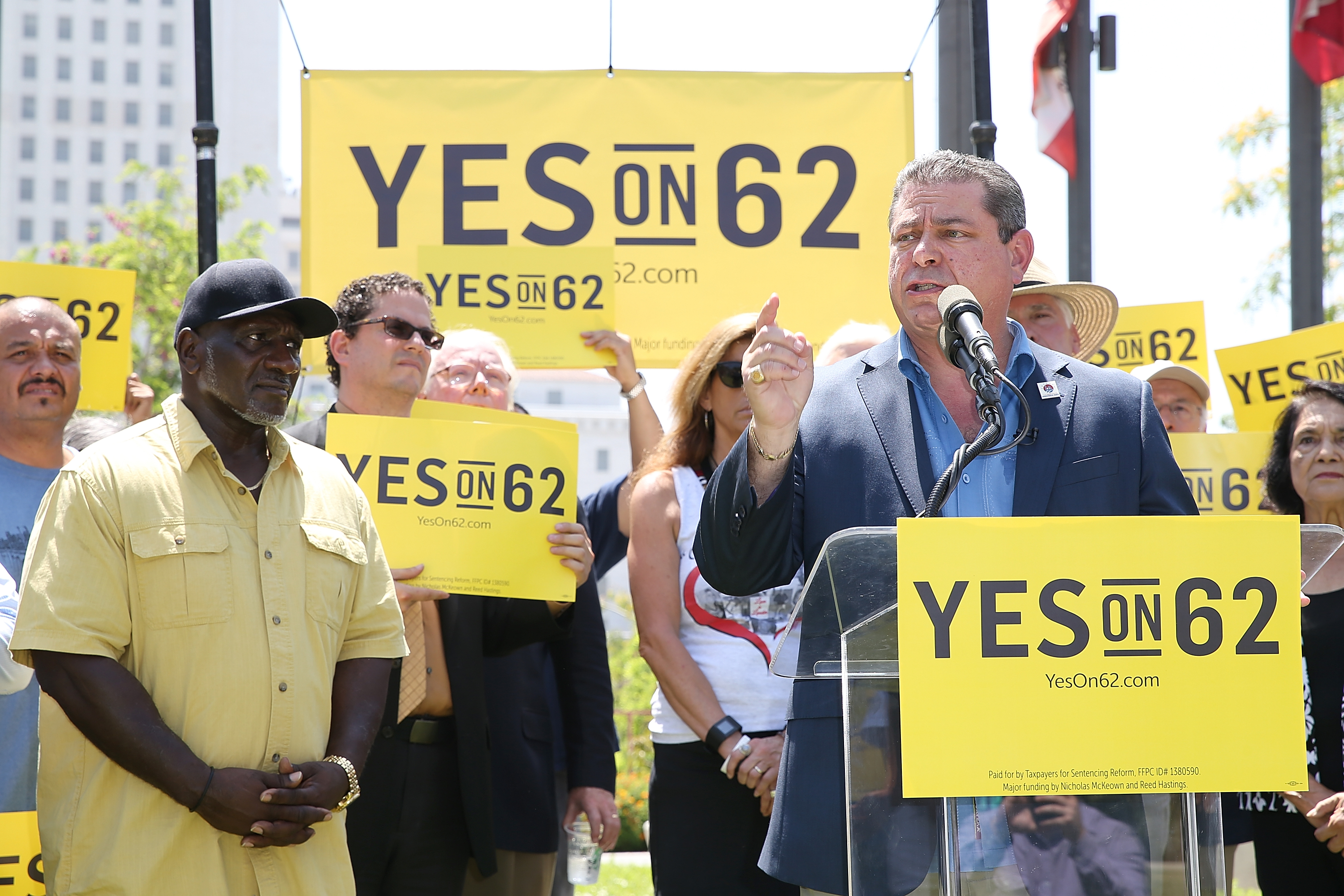 Chairman of the Los Angeles County Democratic Party Eric Bauman (R) speaks onstage during the Yes on Prop 62 Coalition Announcement at Los Angeles Grand Park on July 14, 2016 in Los Angeles, California. (Phillip Faraone/Getty Images for Yes on Prop 62)