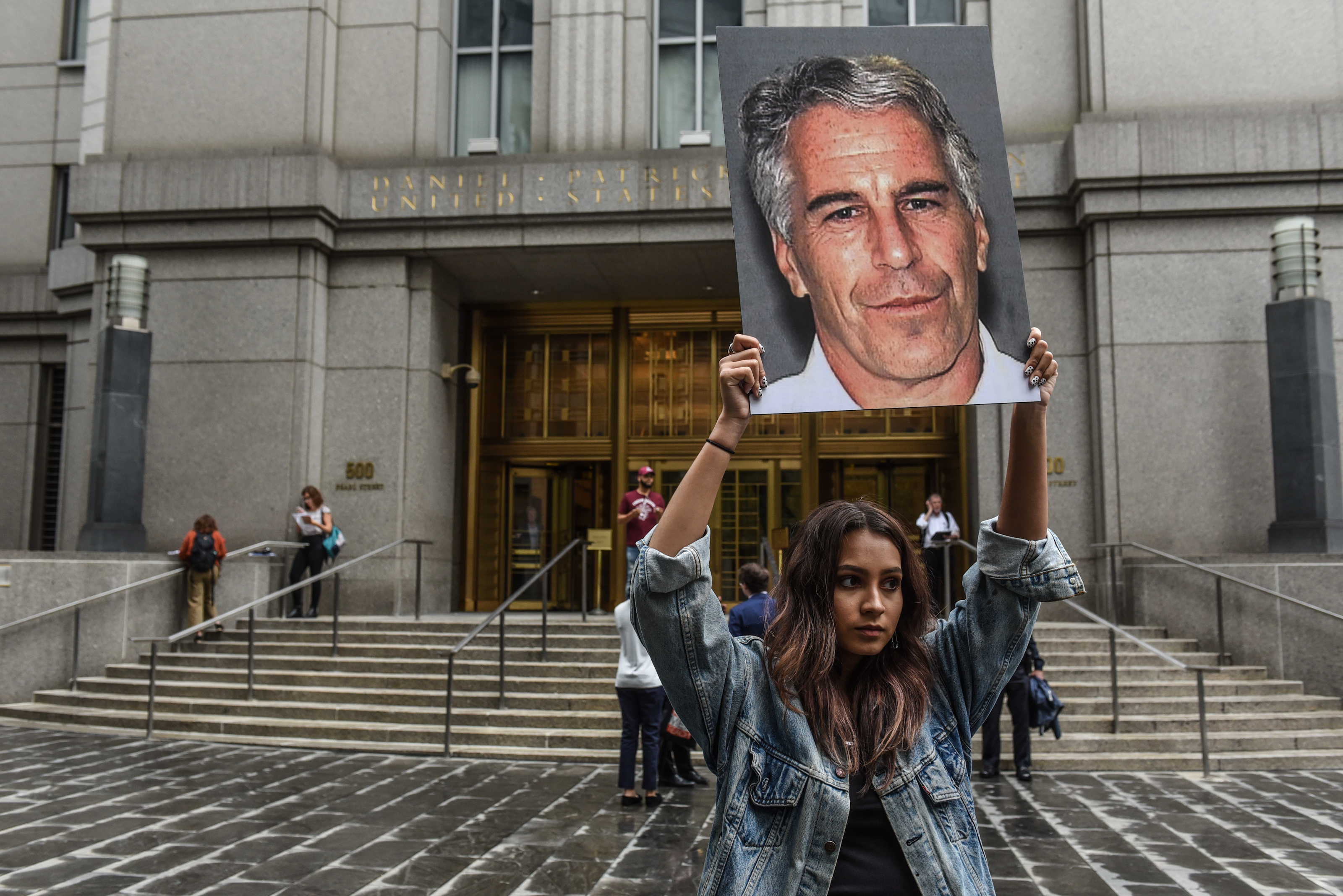 NEW YORK, NY - JULY 08: A protest group called "Hot Mess" hold up signs of Jeffrey Epstein in front of the federal courthouse on July 8, 2019 in New York City. According to reports, Epstein will be charged with one count of sex trafficking of minors and one count of conspiracy to engage in sex trafficking of minors. (Photo by Stephanie Keith/Getty Images)