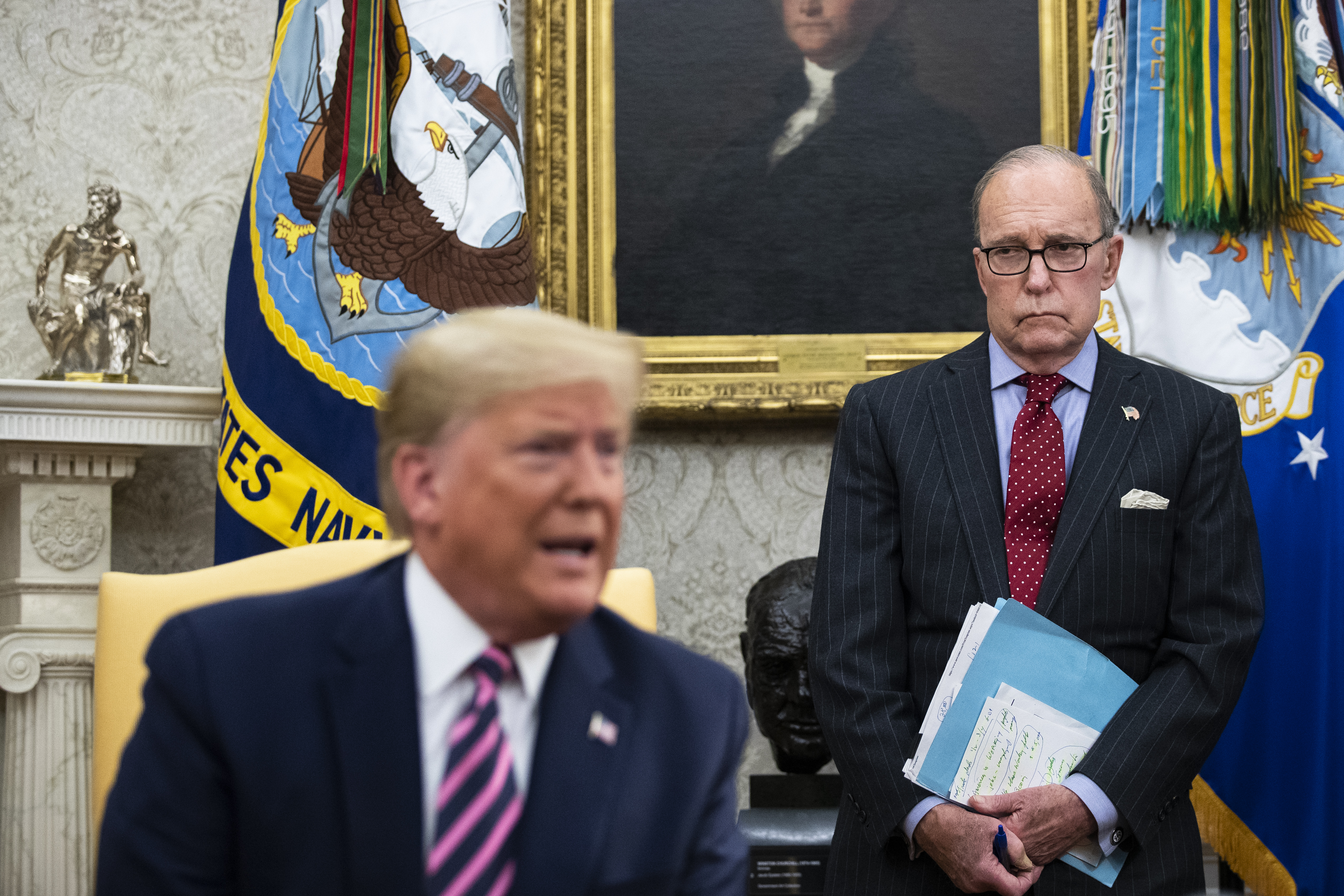 National Economic Council Director Larry Kudlow (R) looks on as U.S. President Donald Trump speaks to reporters in the Oval Office of the White House. (Drew Angerer/Getty Images)