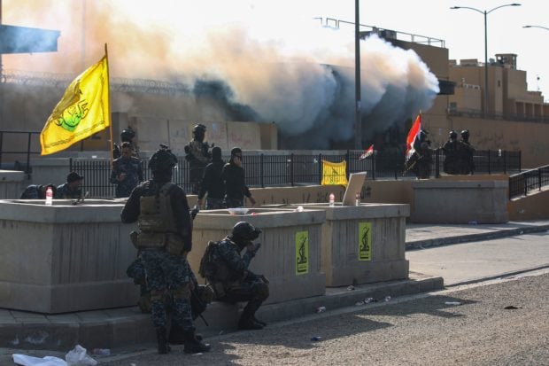 Iraqi security forces are deployed in front of the US embassy in the capital Baghdad, after an order from the Hashed al-Shaabi paramilitary force to supporters to leave the compound on January 1, 2020. - Thousands of Iraqi supporters of the largely Iranian-trained Hashed had encircled and vandalised the embassy compound yesterday, outraged by US air strikes that killed 25 fighters of the military network over the weekend.(Photo by AHMAD AL-RUBAYE/AFP via Getty Images)