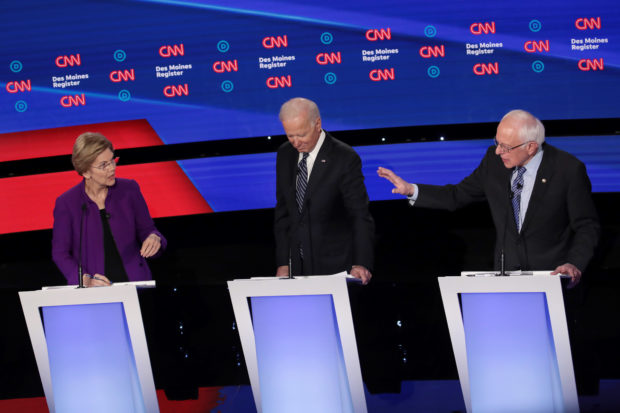 DES MOINES, IOWA - JANUARY 14: Sen. Elizabeth Warren (D-MA) and Sen. Bernie Sanders (I-VT) (R) debate as former Vice President Joe Biden listens during the Democratic presidential primary debate at Drake University on January 14, 2020 in Des Moines, Iowa. Six candidates out of the field qualified for the first Democratic presidential primary debate of 2020, hosted by CNN and the Des Moines Register. (Photo by Scott Olson/Getty Images)