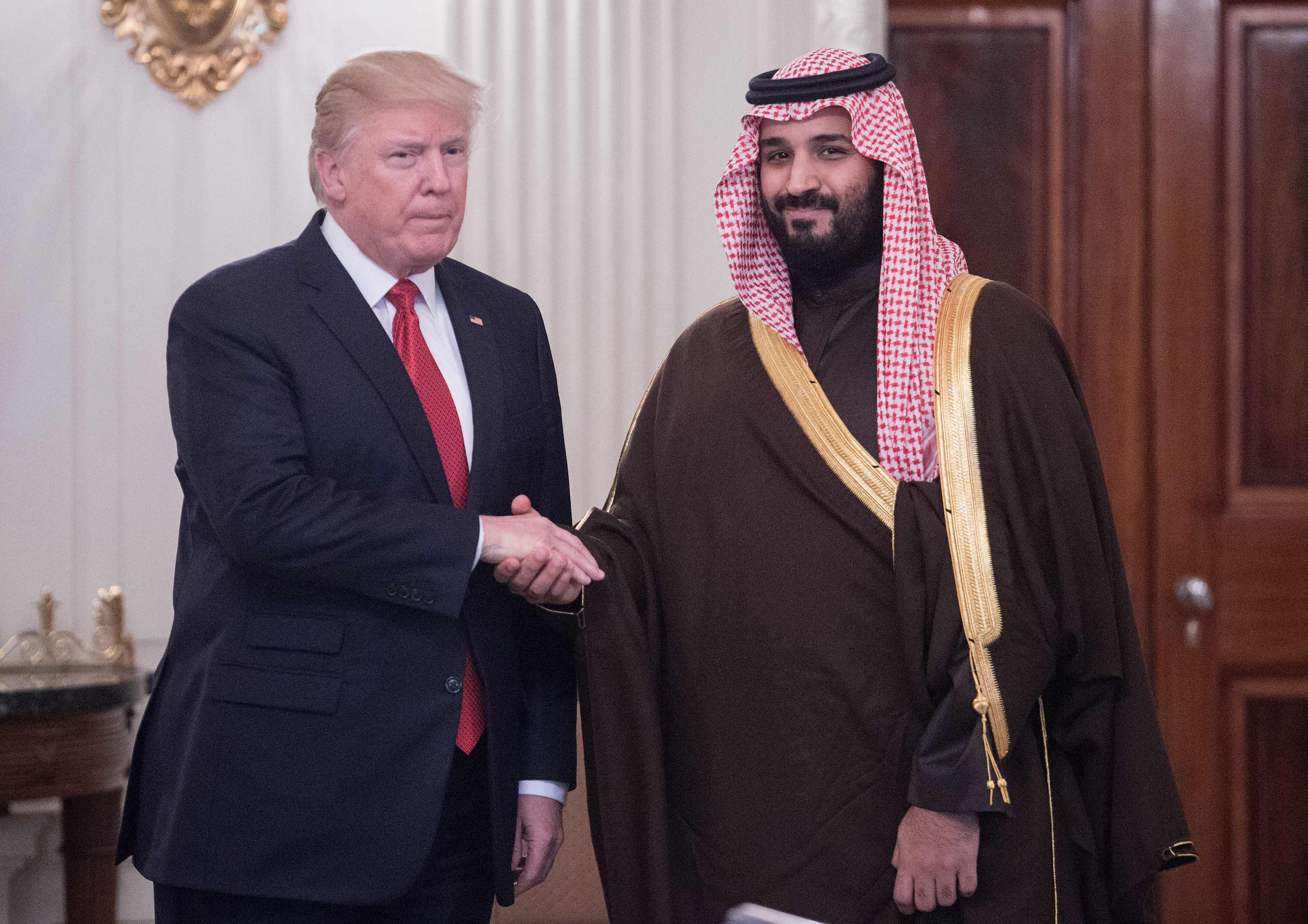 US President Donald Trump and Saudi Deputy Crown Prince and Defense Minister Mohammed bin Salman shake hands in the State Dining Room before lunch at the White House in Washington, DC, on March 14, 2017. Trump welcomed the prince to the Oval Office, as both countries expect to improve ties that were frequently strained under Barack Obama's administration. Saudi Arabia is likely to welcome Trump's harder line on its arch-rival Iran and there is likely to be less friction over Riyadh's war against Iranian-backed Huthi rebels in Yemen. (Photo: NICHOLAS KAMM/AFP via Getty Images)