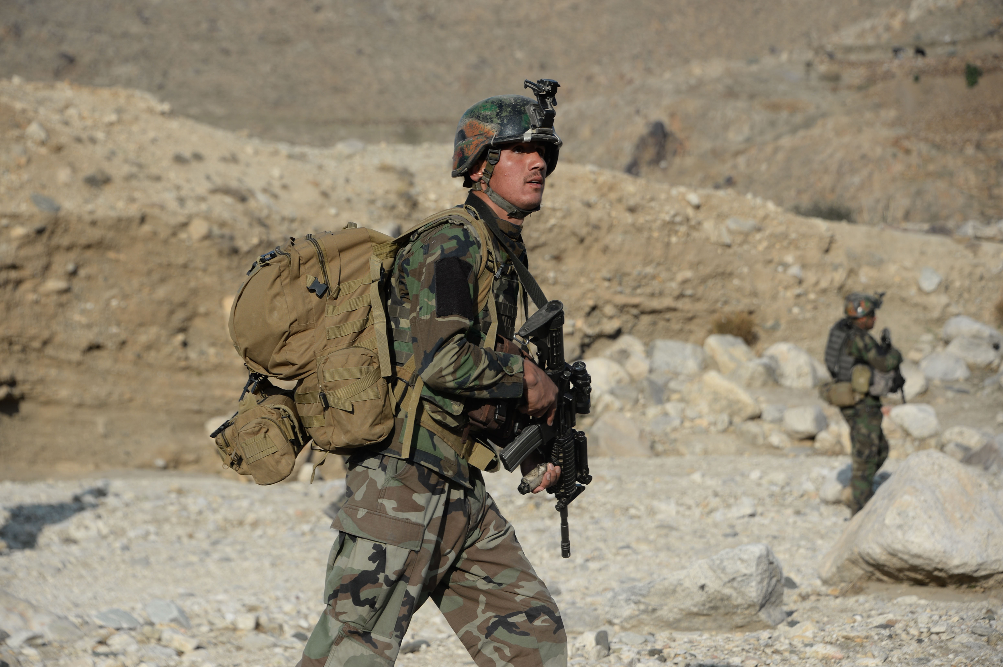 In this photograph taken on January 3, 2018, Afghan commandos forces patrol during ongoing US-Afghan military operation against Islamic State militants in Achin district of Nangarhar province. Afghan security forces are conducting most of the fighting against the Taliban and other insurgent groups as US troops operate alongside them in a training capacity and are frequently on the front lines. / AFP PHOTO / NOORULLAH SHIRZADA (Photo credit should read NOORULLAH SHIRZADA/AFP via Getty Images)