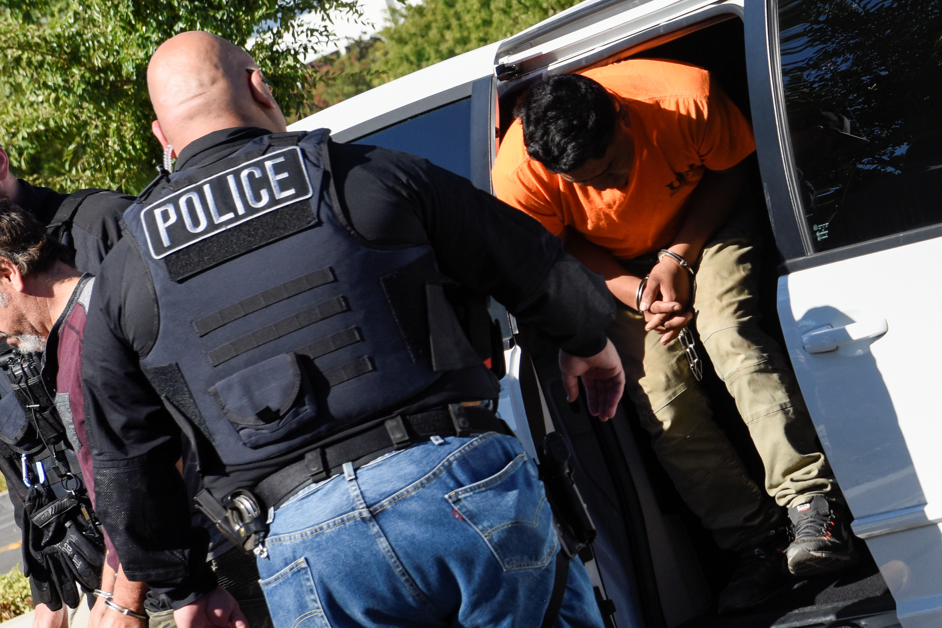 ICE Enforcement and Removal Operations (ERO) officers transfer an unauthorized immigrant with a criminal record during an Immigration and Customs Enforcement (ICE) operation in San Jose