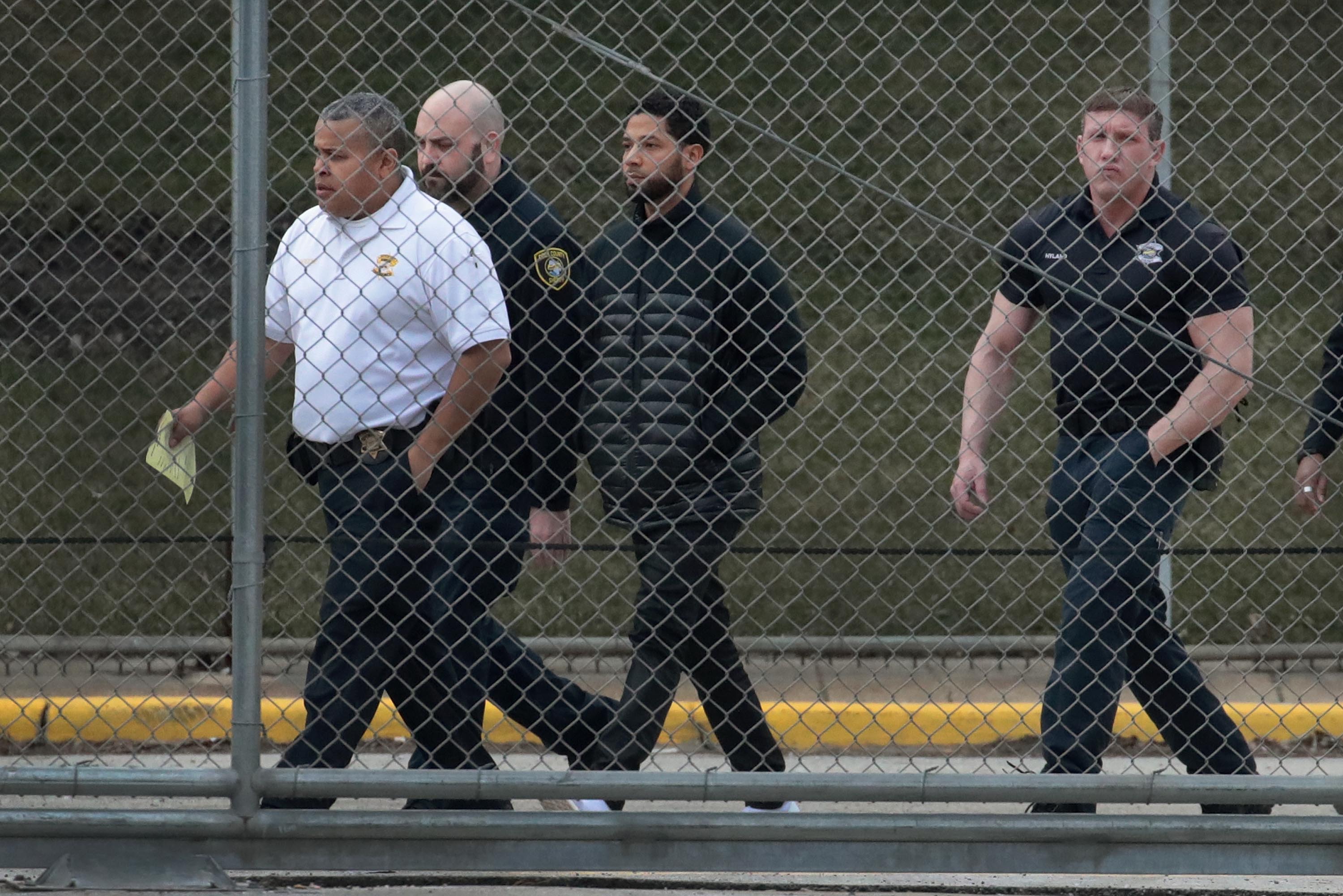 Guards walk with Empire actor Jussie Smollett before he is released on bond from Cook County jail on February 21, 2019 in Chicago, Illinois. Smollett has been accused with arranging a homophobic, racist attack against himself in an attempt to raise his profile because he was dissatisfied with his salary. (Photo by Scott Olson/Getty Images)