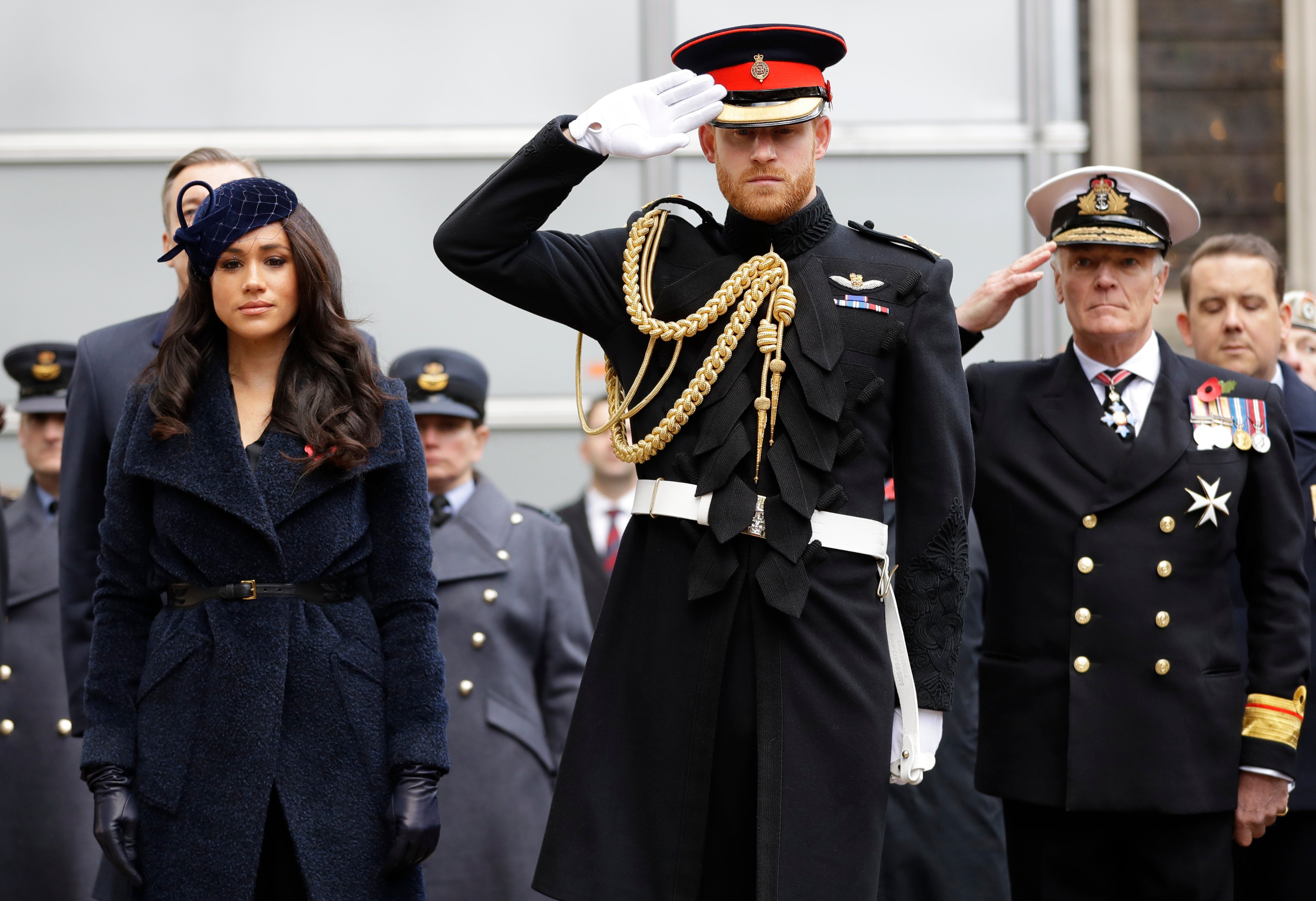 Britain's Prince Harry, Duke of Sussex and his wife Meghan, Duchess of Sussex pay their respects after laying a Cross of Remembrance in front of wooden crosses from the Graves of Unknown British Soldiers from the First and Second World Wars, during their visit to the Field of Remembrance at Westminster Abbey in central London on November 7, 2019. - The Field of Remembrance is organised by The Poppy Factory, and has been held in the grounds of Westminster Abbey since November 1928, when only two Remembrance Tribute Crosses were planted. In the run-up to Armistice Day, many Britons wear a paper red poppy -- symbolising the poppies which grew on French and Belgian battlefields during World War I -- in their lapels. (Photo by KIRSTY WIGGLESWORTH/POOL/AFP via Getty Images)