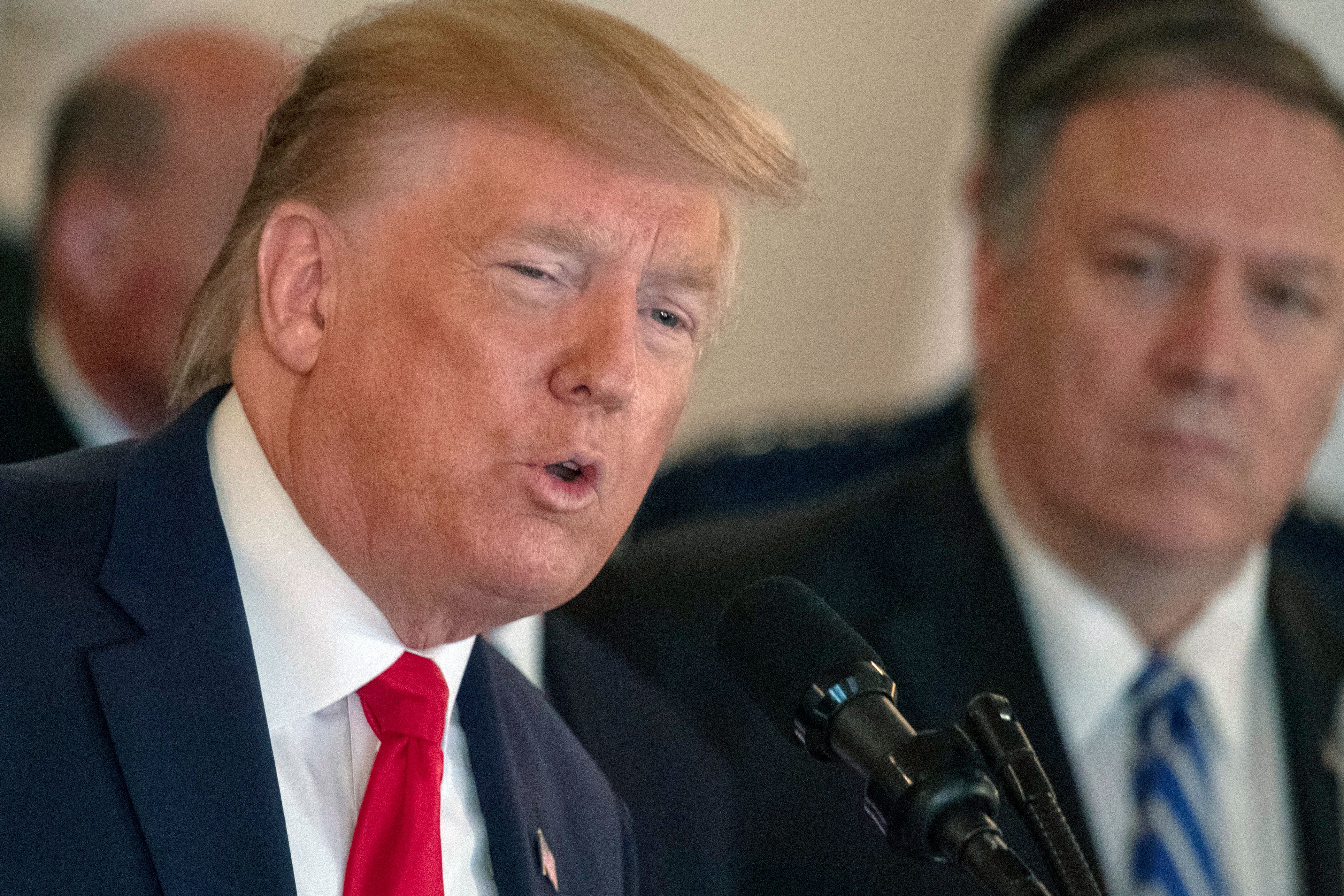 US Secretary of State Mike Pompeo(R) listens as US President Donald Trump speaks about the situation with Iran in the Grand Foyer of the White House in Washington, DC, January 8, 2020. (Photo by ERIC BARADAT/AFP via Getty Images)