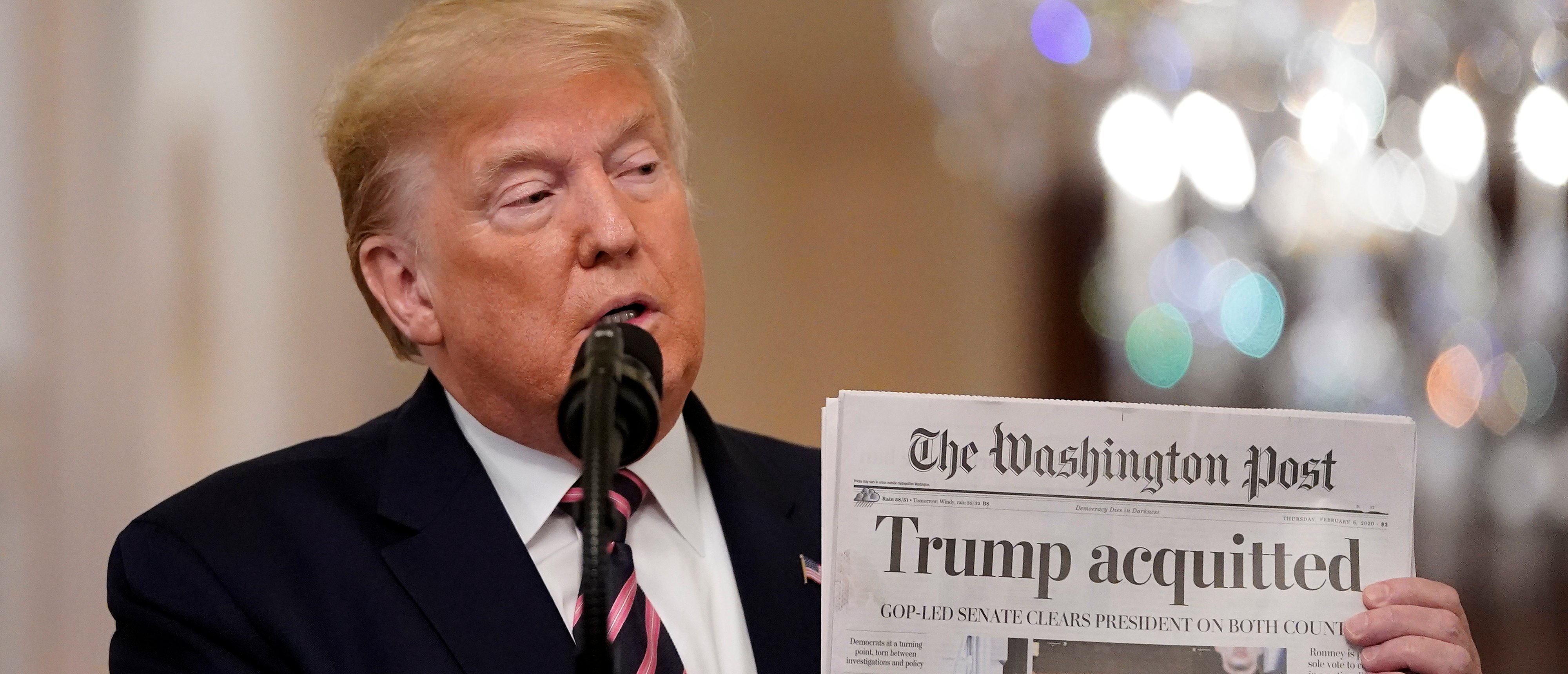 WASHINGTON, DC - FEBRUARY 06: U.S. President Donald Trump holds a copy of The Washington Post as he speaks in the East Room of the White House one day after the U.S. Senate acquitted on two articles of impeachment, ion February 6, 2020 in Washington, DC. After five months of congressional hearings and investigations about President Trump’s dealings with Ukraine, the U.S. Senate formally acquitted the president on Wednesday of charges that he abused his power and obstructed Congress. (Photo by Drew Angerer/Getty Images)