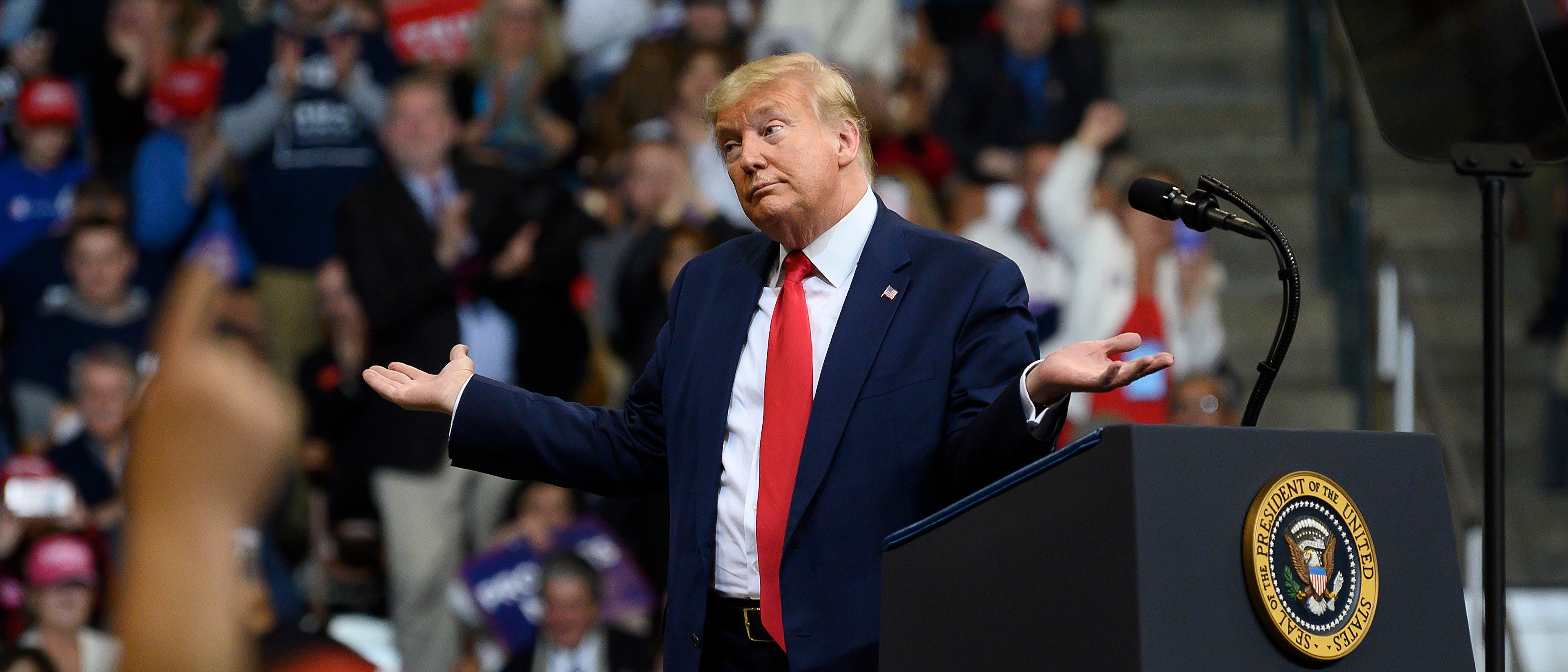 US President Donald Trump looks at his supporters after reading words from Al Wilson's song "The Snake" during a rally in Manchester, New Hampshire on February 10, 2020. (Photo by JIM WATSON / AFP) (Photo by JIM WATSON/AFP via Getty Images)