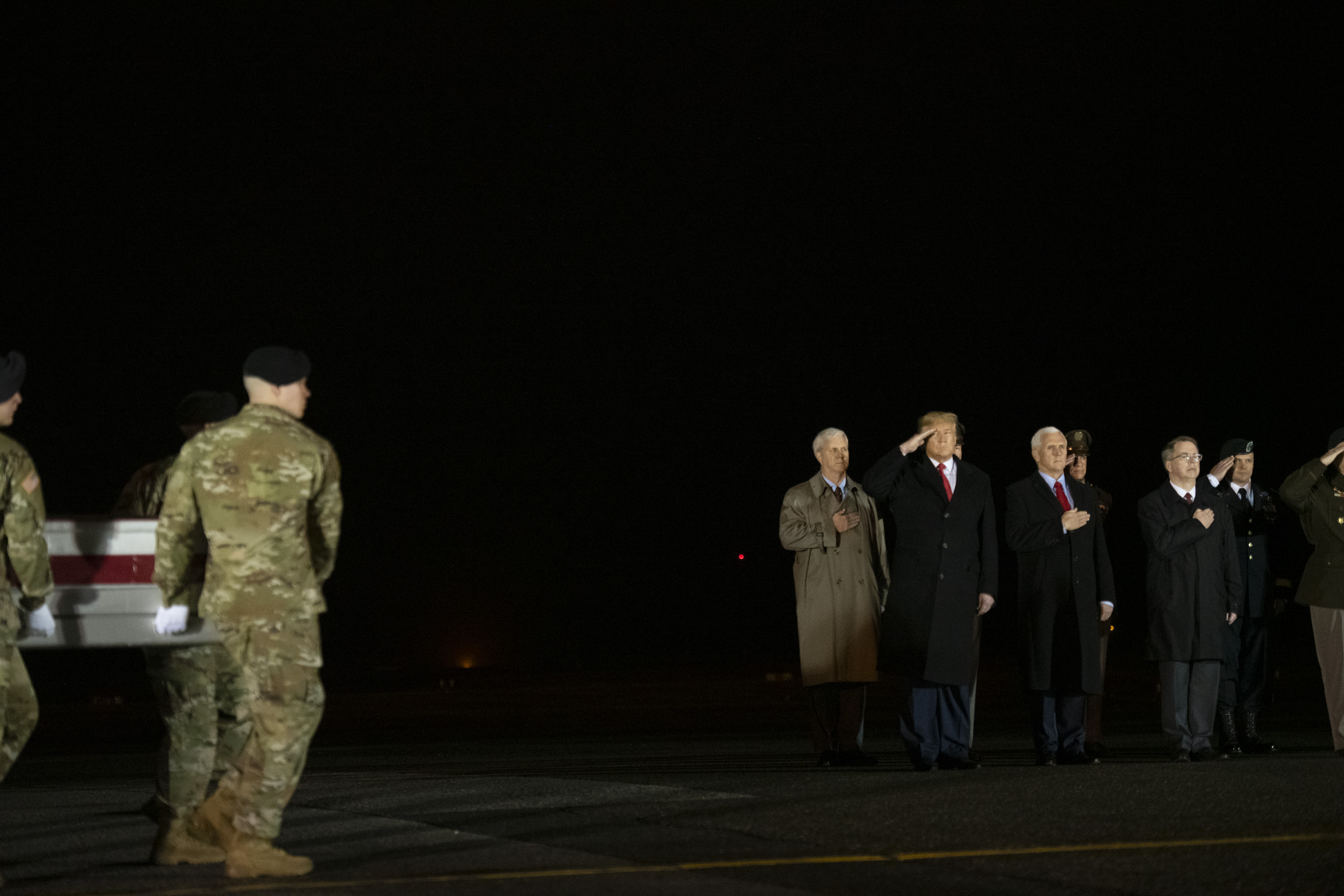 DOVER, DE - FEBRUARY 10: (L-R) U.S. President Donald J. Trump and Vice President Mike Pence watch as military personnel carry a transfer case for fallen service member, U.S. Army Sgt. 1st Class Javier J. Gutierrez, 28, during a dignified transfer at Dover Air Force Base on February 10, 2020 in Dover, Delaware. Gutierrez and U.S. Army Sgt. 1st Class Antonio R. Rodriguez were both killed in an attack in the Nangarhar province of Afghanistan on Saturday, according to a Department of Defense release. (Photo by Mark Makela/Getty Images)