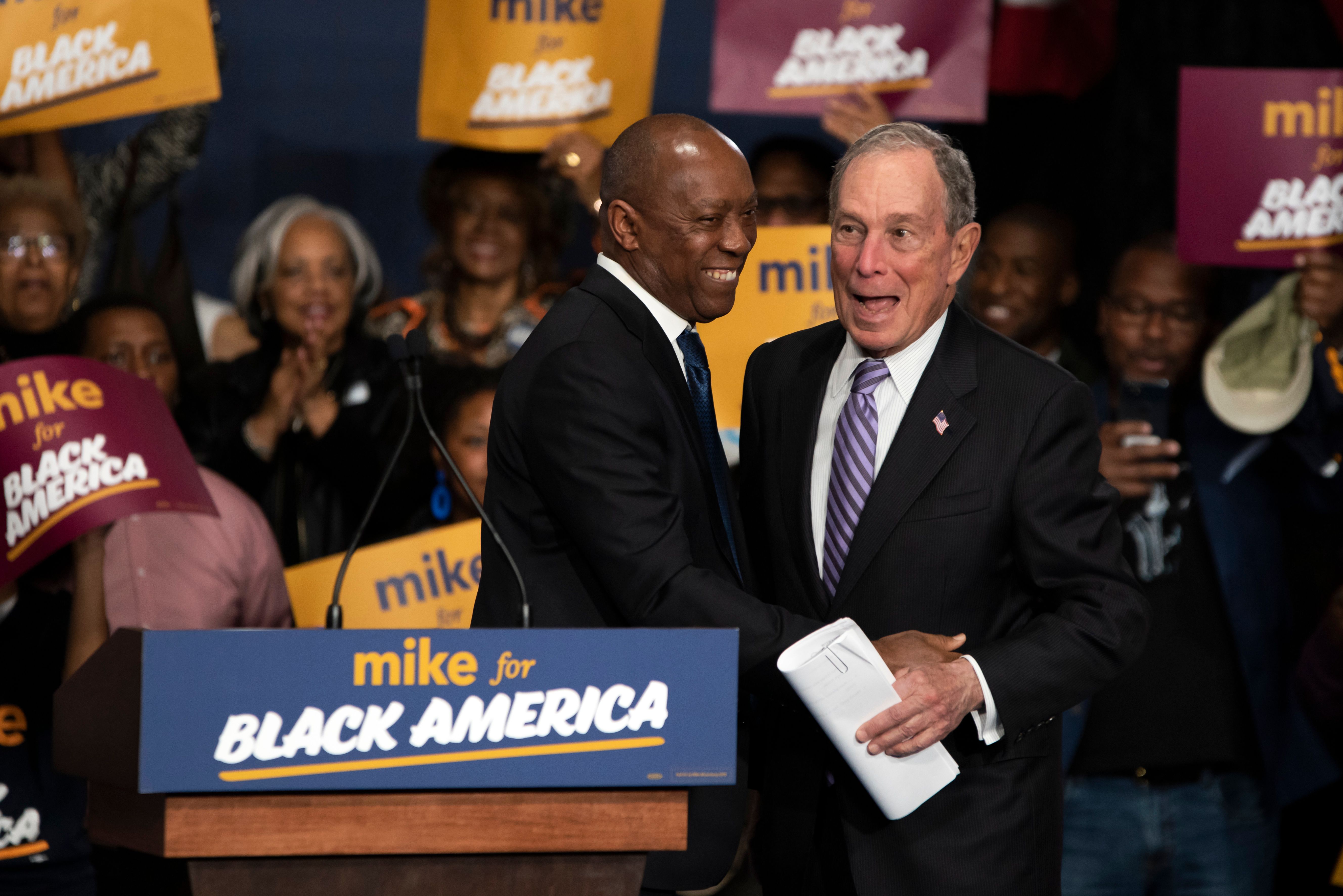 Democratic presidential hopeful Mike Bloomberg (R) arrives to speak at the "Mike for Black America Launch Celebration" at the Buffalo Soldier National Museum in Houston, Texas, on February 13, 2020. (MARK FELIX/AFP /AFP via Getty Images)