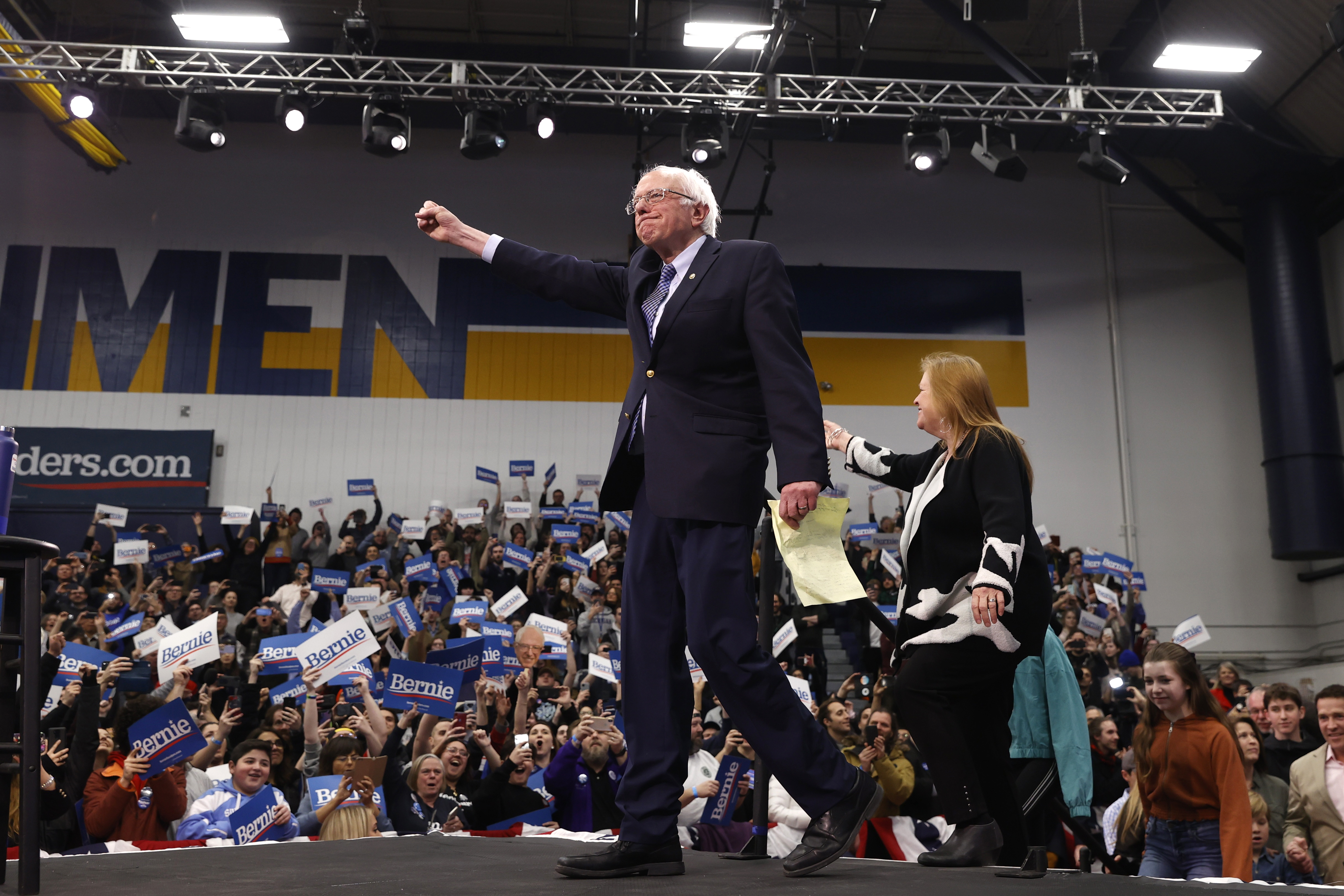 Democratic U.S. presidential candidate Senator Bernie Sanders pumps his fist and is accompanied by his wife Jane O’Meara Sanders as he arrives to speak at his New Hampshire primary night rally in Manchester, N.H., U.S., February 11, 2020. REUTERS/Mike Segar - HP1EG2C0E5I9E