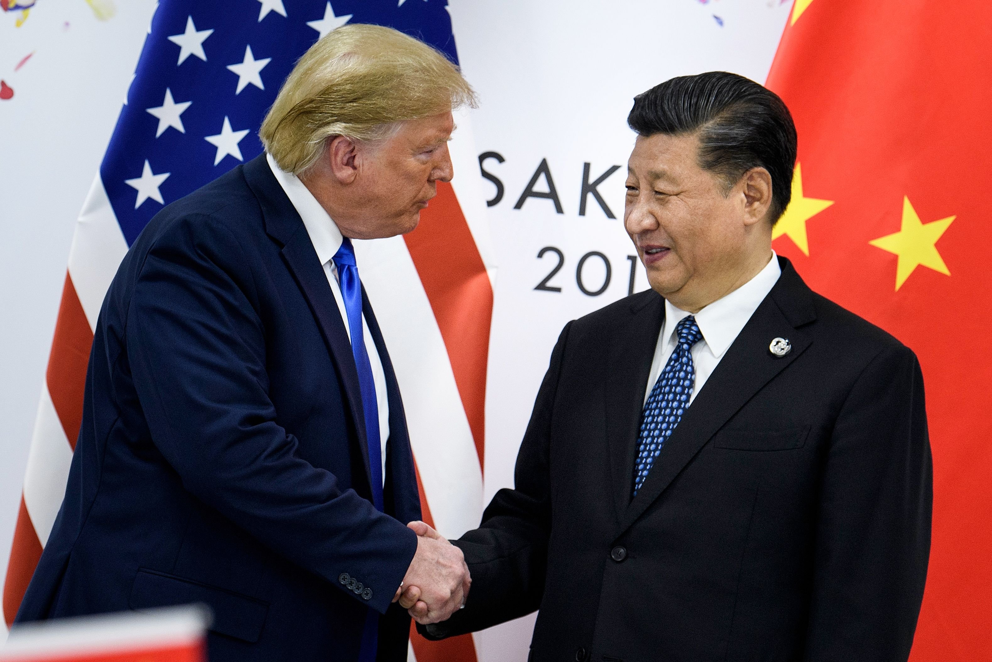 June 28, 2019 -- China's President Xi Jinping (R) shakes hands with US President Donald Trump before a bilateral meeting on the sidelines of the G20 Summit in Osaka. - From the Arab Spring to bloodletting in Syria, from Obama to Trump, from terror in the streets of Paris to Brexit, the 2010s began with hope for a more equitable world, and end with a slide towards nationalistic populism. (Photo by BRENDAN SMIALOWSKI/AFP via Getty Images)