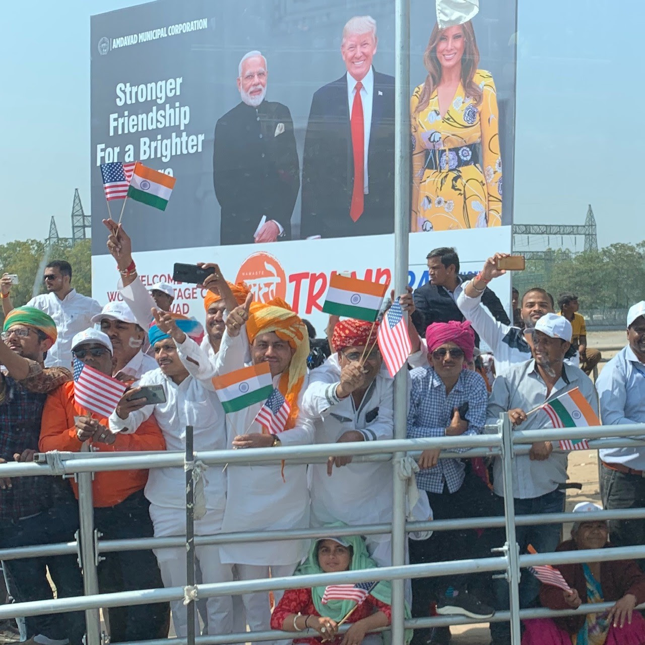Indian citizens wave American and Indian flags as Trump's motorcade passed by February 24, 2020. (White House Press Pool)