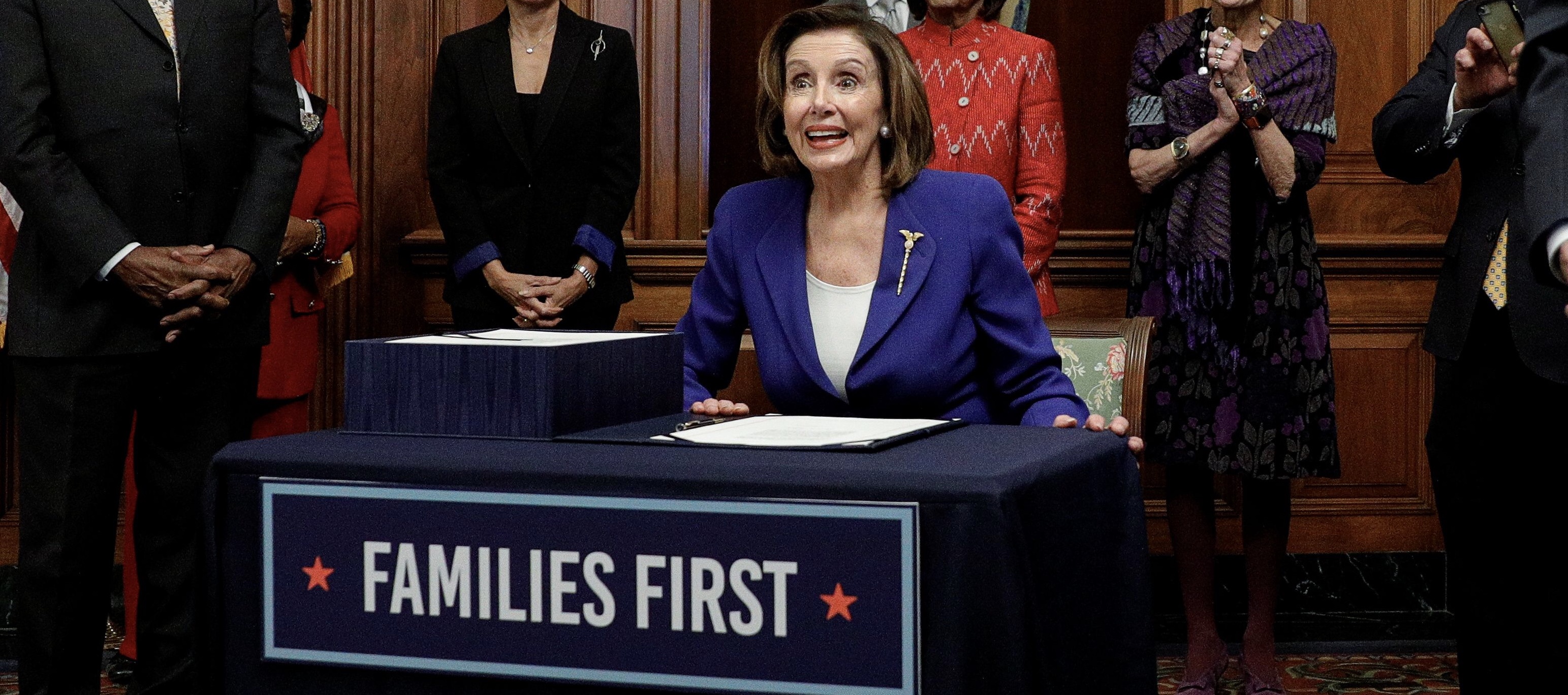 U.S. House Speaker Nancy Pelosi (D-CA) is applauded during a signing ceremony after the House of Representatives approved a $2.2 trillion coronavirus aid package at the U.S. Capitol in Washington, U.S., March 27, 2020. REUTERS/Tom Brenner