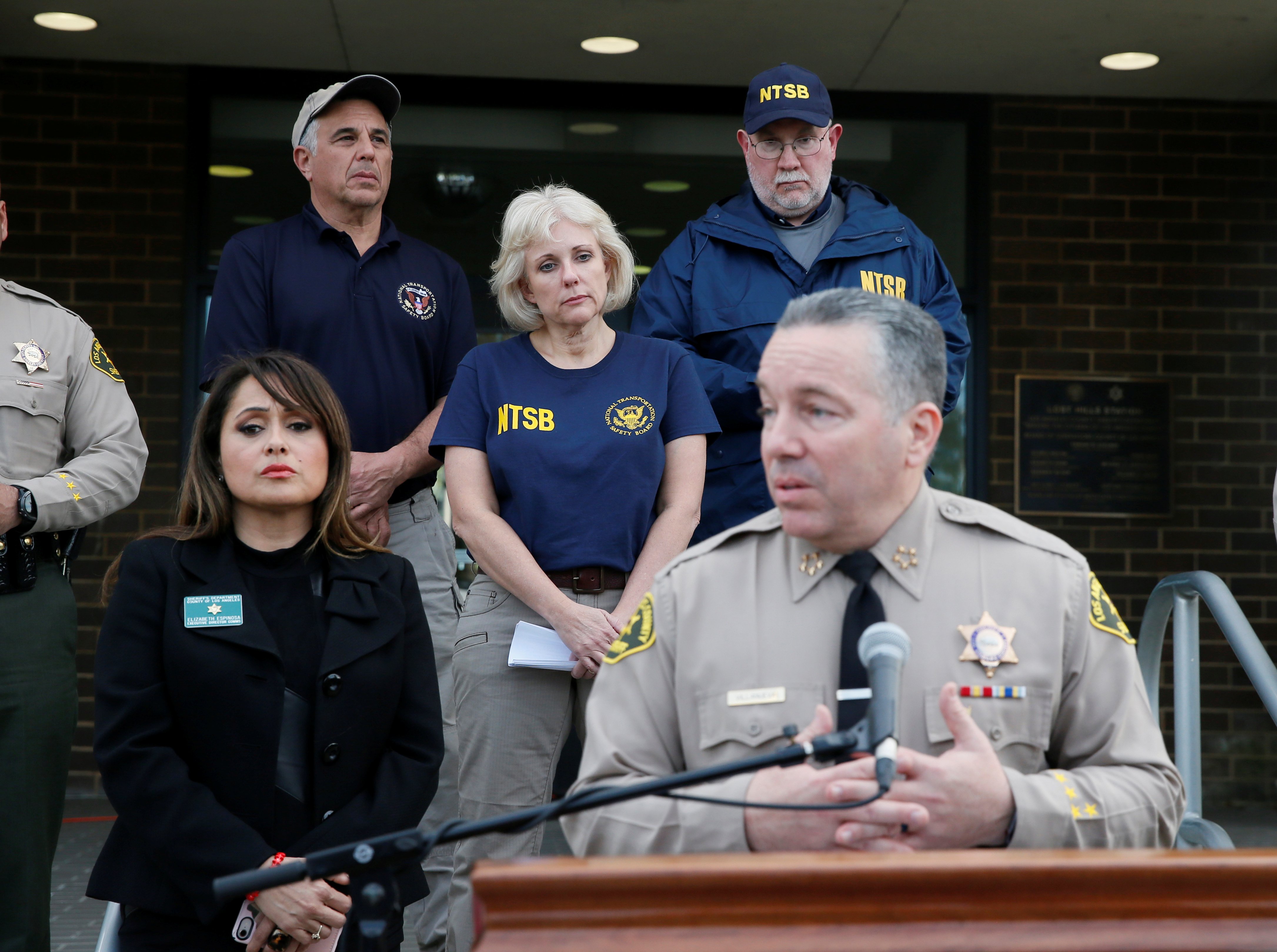 NTSB Board Member, Jennifer Homendy (3rd-L) listens along with other NTSB members while Los Angeles County Sheriff Alex Villanueva speaks about the helicopter crash of NBA star Kobe Bryant during a media availability in Calabasas, California, U.S., Jan. 27, 2020. REUTERS/Danny Moloshok 