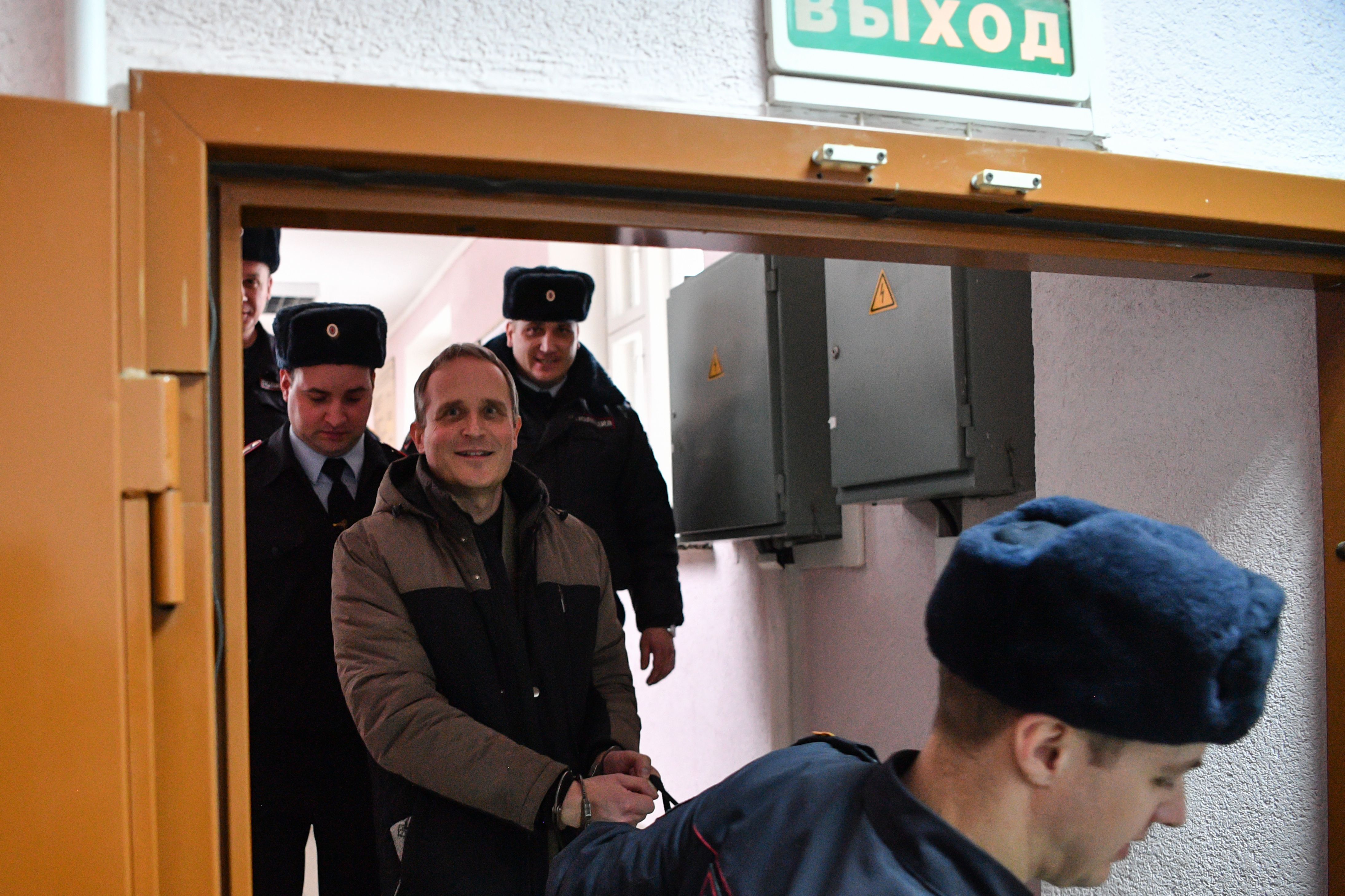 Dennis Christensen is escorted inside a courthouse following the verdict announcement in the town of Oryol on February 6, 2019 (MLADEN ANTONOV/AFP via Getty Images)