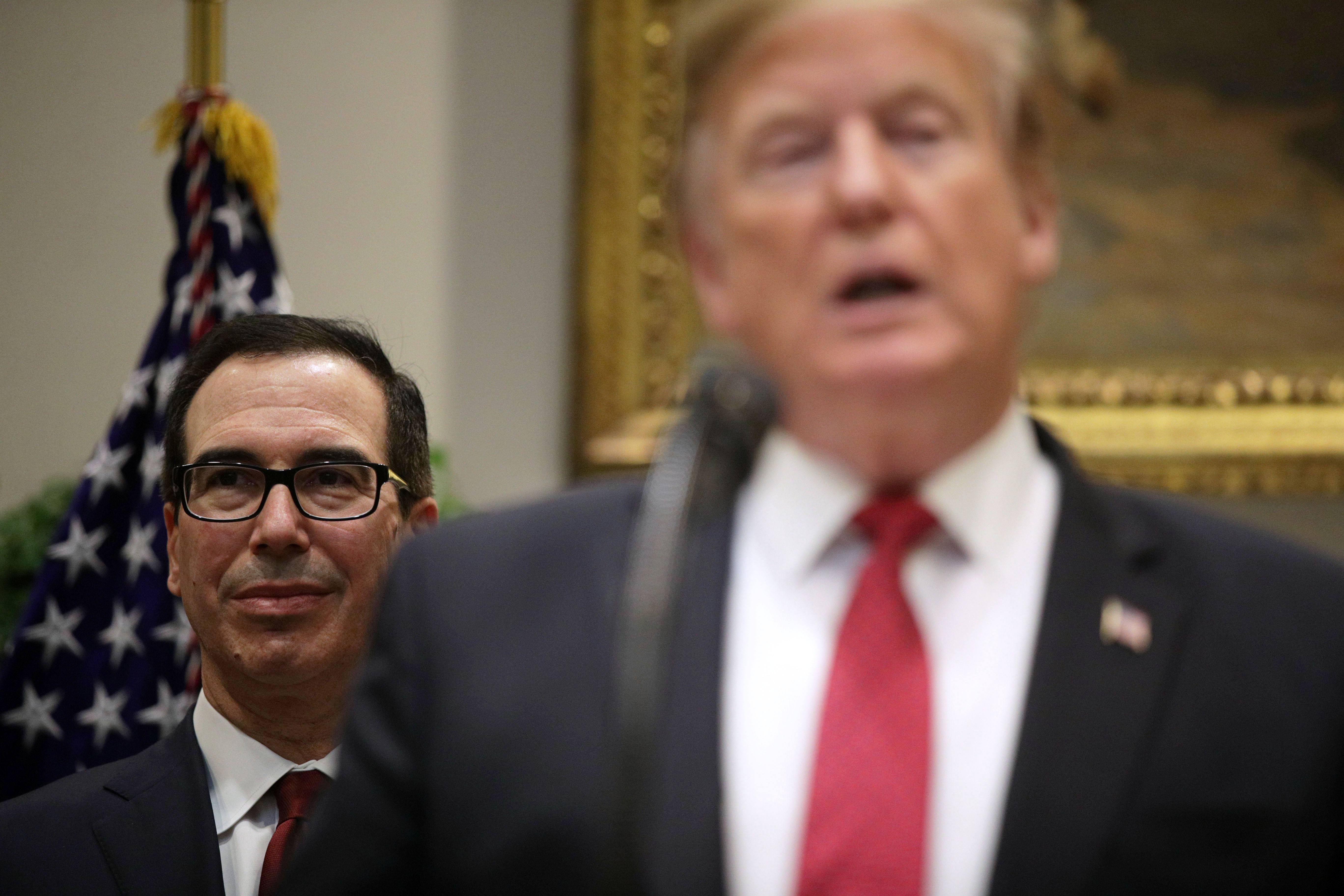 WASHINGTON, DC - FEBRUARY 06: (AFP-OUT) U.S. President Donald Trump speaks as Secretary of the Treasury Steven Mnuchin (L) listens during a Roosevelt Room event at the White House February 6, 2019 in Washington, DC. President Trump announced that Under Secretary of the Treasury for International Affairs David Malpass will be the U.S. candidate for election as the next president of the World Bank. (Photo by Alex Wong/Getty Images)