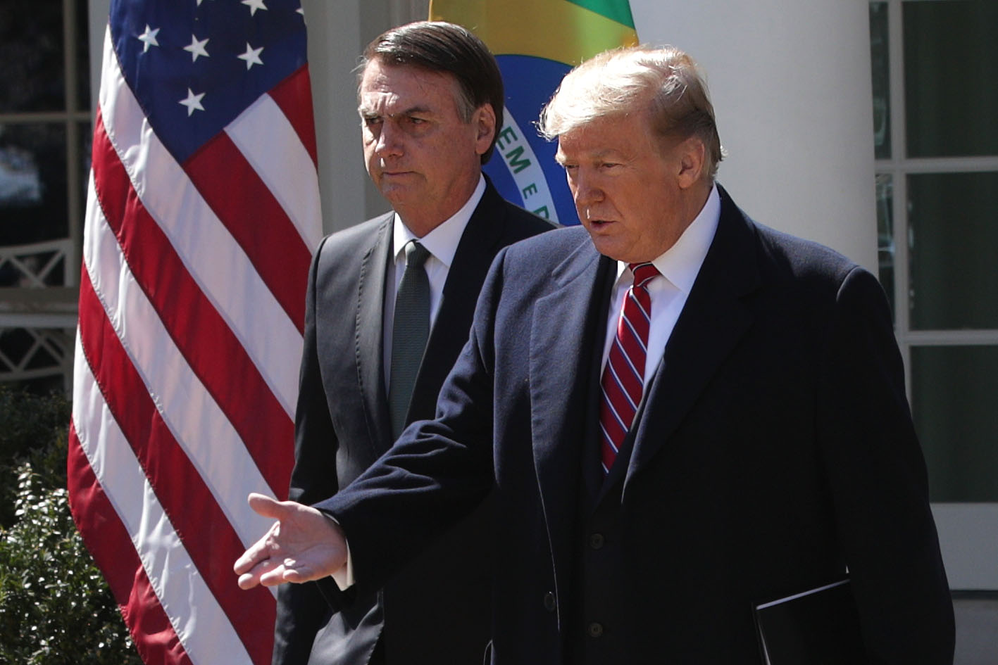 WASHINGTON, DC - MARCH 19: U.S. President Donald Trump (R) and Brazilian President Jair Bolsonaro (L) approach the podiums for a joint news conference at the Rose Garden of the White House March 19, 2019 in Washington, DC. President Trump is hosting President Bolsonaro for a visit and bilateral talks at the White House today. (Photo by Alex Wong/Getty Images)