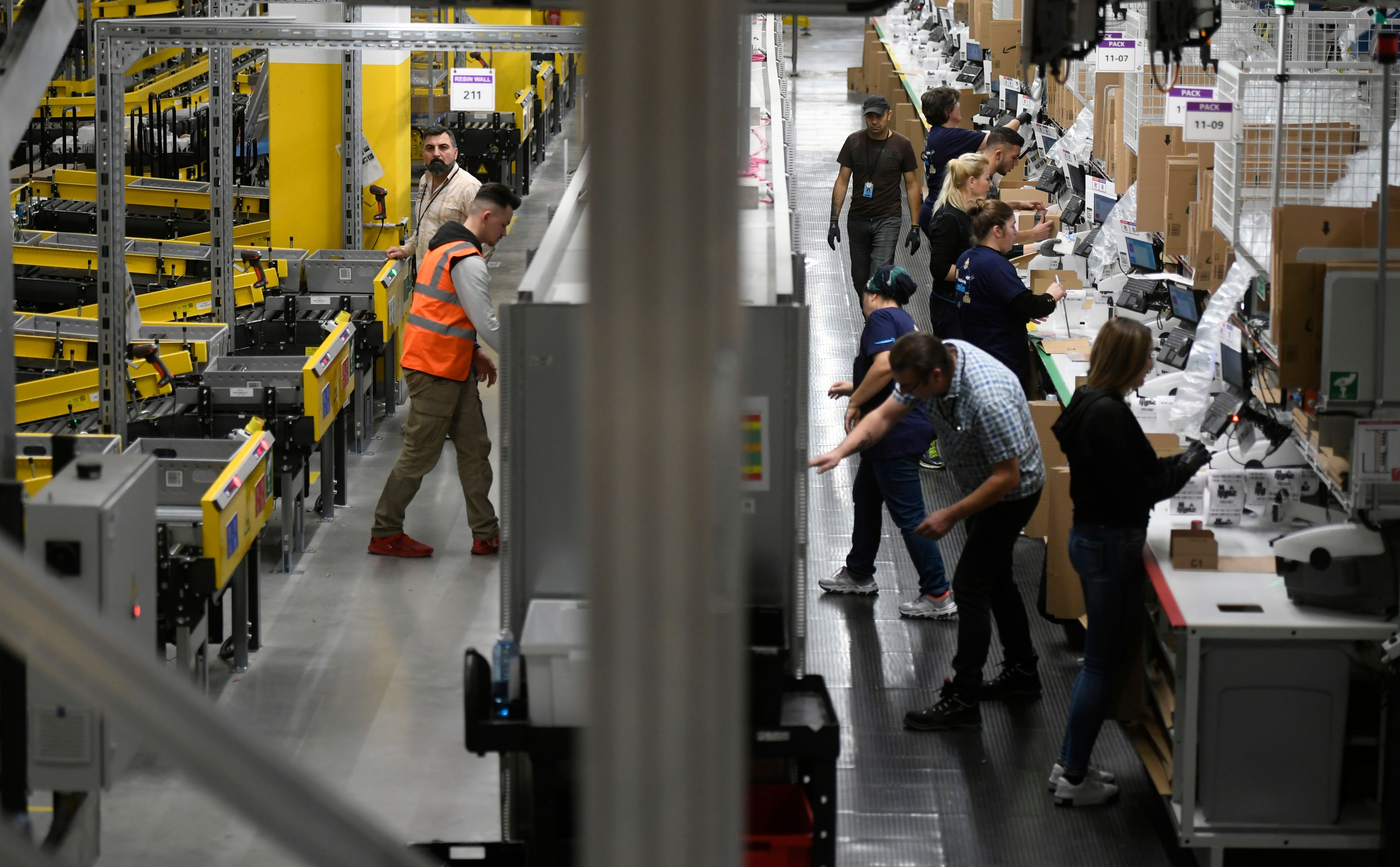 The picture shows employees working at the distribution center of US online retail giant Amazon in Moenchengladbach, on December 17, 2019. (INA FASSBENDER/AFP via Getty Images)