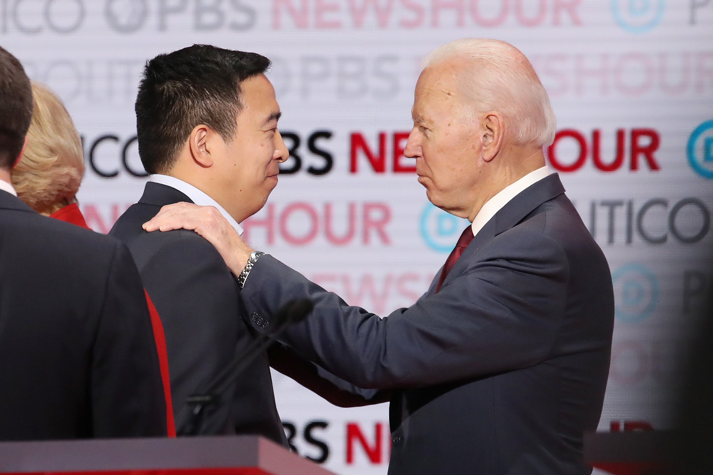 LOS ANGELES, CALIFORNIA - DECEMBER 19: Democratic presidential candidate Andrew Yang (L) speaks with former Vice President Joe Biden during the Democratic presidential primary debate at Loyola Marymount University on December 19, 2019 in Los Angeles, California. Seven candidates out of the crowded field qualified for the 6th and last Democratic presidential primary debate of 2019 hosted by PBS NewsHour and Politico. (Photo by Justin Sullivan/Getty Images)